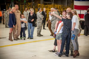 Tech. Sgt. Chris Seguin, 934th Maintenance Squadron, takes a family selfie before deploying to Southwest Asia Sept. 9.  Friends and family gathered to say goodbye during a deployment ceremony as more than 100 934th Airlift Wing Airmen leave from the Minneapolis-St. Paul Air Reserve Station, Minn.  (U.S. Air Force photo by Shannon McKay/Released)