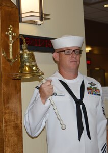 Petty Officer 1st Class John Furr, Naval Health Clinic Charleston hospital corpsman, rings a bell three times in the NHCC atrium, Sept. 11, 2014, at NHCC on Joint Base Charleston, S.C. Each ring of the bell represented one of the sites terrorists attacked on 9/11 - the World Trade Center, the Pentagon and Shanksville, Pa. (U.S. Navy photo/Petty Officer 3rd Class Caralyn Mulyk)