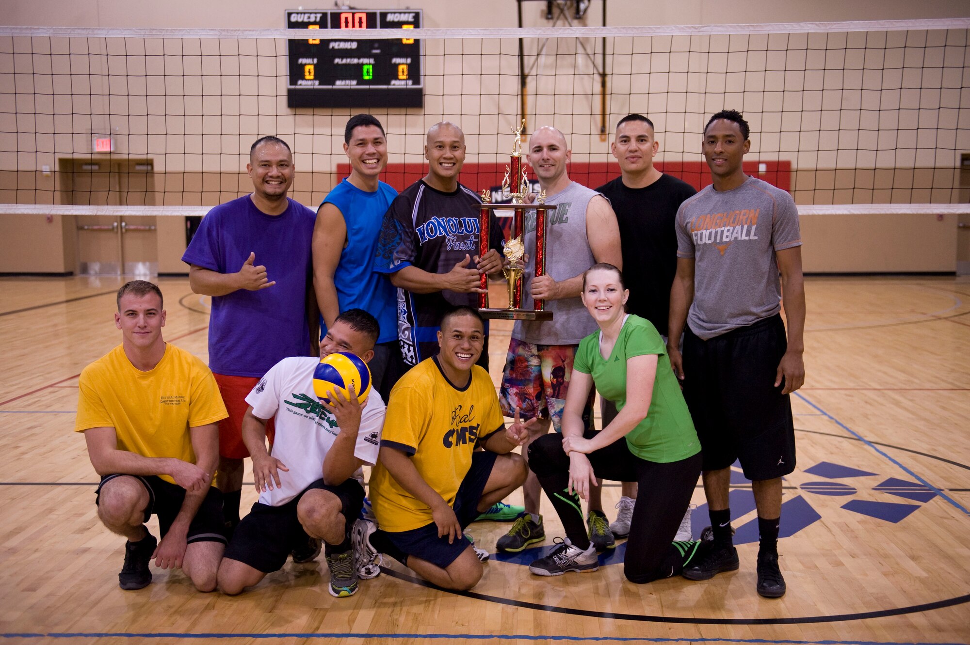 Members of the 823rd Maintenance Squadron pose for a photo with the intramural volleyball championship trophy at the Warrior Fitness Center on Nellis Air Force Base, Nev., Sept. 11, 2014. The championship match lasted three hours and involved six games between the 823rd MXS and the 99th Medical Group. The 823rd MXS defeated the 99th MDG in four out of the six games played and claimed the 2014 Intramural Volleyball Championship title. (U.S. Air Force photo by Airman 1st Class Rachel Loftis)