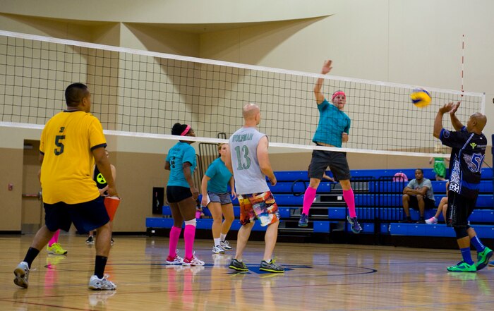 Members of the 823rd Maintanence Squadron (left) block a spike from the 99th Medical Group during the  intramural volleyball championship at the Warrior Fitness Center on Nellis Air Force Base, Nev. Sept. 11, 2014. The 823rd MXS came in to the championship as the underdogs, but  defeated the 99th MDG 25 to 20 in the final match to claim the title. (U.S. Air Force photo by Airman 1st Class Rachel Loftis)
