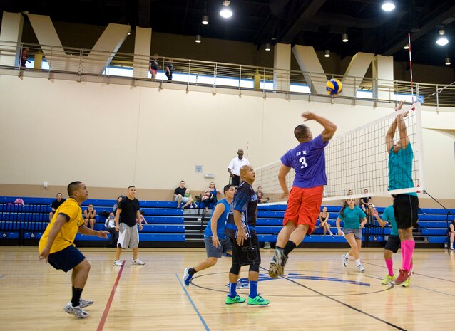 Members of the 823rd Maintanence Squadron (left) and 99th Medical Group (right) intramural volleyball teams participate in the intramural volleyball championship at the Warrior Fitness Center on Nellis Air Force Base, Nev. Sept. 11, 2014. The championship featured an intense six-game match to decide the winner of the 2014 title. Members of both teams pulled out all the stops, hitting volleyballs off the wall to keep them in play, high-speed spikes, and constant diving to keep the game going. (U.S. Air Force photo by Airman 1st Class Rachel Loftis)
