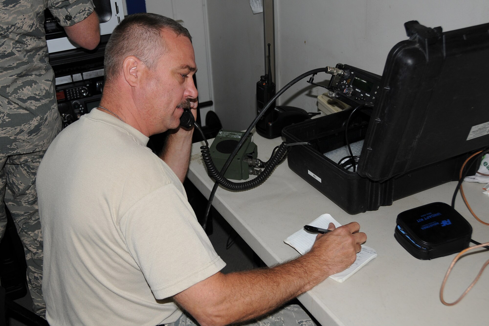 Air Force Reserve Tech. Sgt. Donald Adkins, a Radio Frequency Transmission Technician assigned to the 910th Communications Squadron (CS), completes a radio check with the aircrew of a C-130 Hercules aircraft performing an aerial spray sortie over nearby Saylor Creek Bombing Range here, Sept. 16, 2014. A five-person 910th CS team is supporting to the two-week mission through a wide variety of technologies designed to keep all of the 910th’s Citizen Airmen in touch with each other and their home base of Youngstown Air Reserve Station, Ohio while performing their duty in Idaho. The 910th Airlift Wing, based at Youngstown Air Reserve Station, Ohio, is home to the Department of Defense’s only large-area, fixed-wing aerial spray capability. U.S. Air Force photo by Tech. Sgt. Rick Lisum