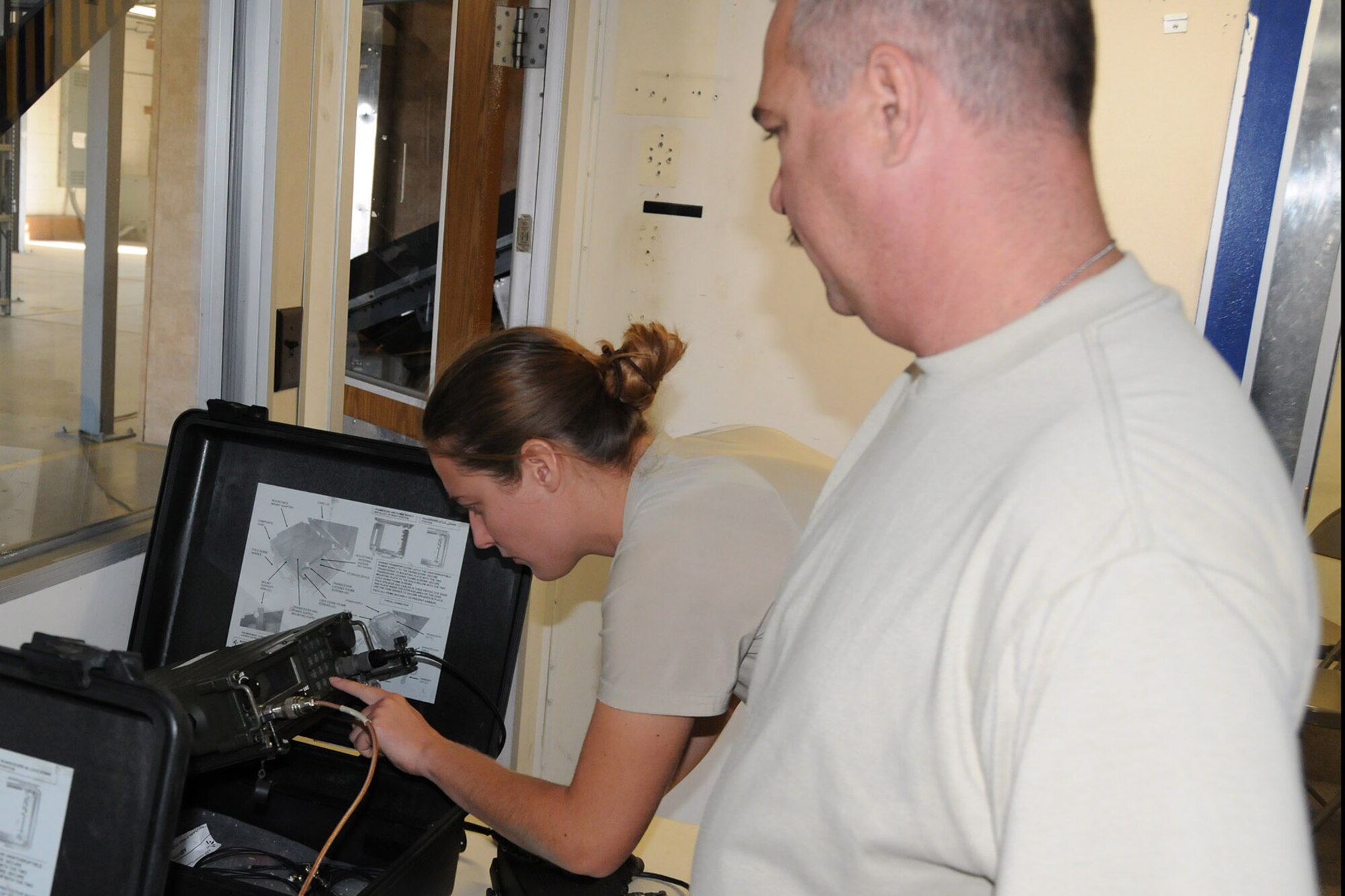 Air Force Reserve Senior Airman Shannon Doherty, a Cyber Systems Operator assigned to the 910th Communications Squadron (CS), adjusts the settings on a radio system while Tech. Sgt. Donald Adkins, 910th CS Radio Frequency Transmission Technician, instructs her in their work center here, Sept. 16, 2014. A five-person 910th CS team is supporting a two-week aerial spray mission through a wide variety of technologies designed to keep all of the 910th’s Citizen Airmen in touch with each other and their home base of Youngstown Air Reserve Station, Ohio while performing their duty in Idaho. The 910th Airlift Wing, based at Youngstown Air Reserve Station, Ohio, is home to the Department of Defense’s only large-area, fixed-wing aerial spray capability. U.S. Air Force photo by Tech. Sgt. Rick Lisum