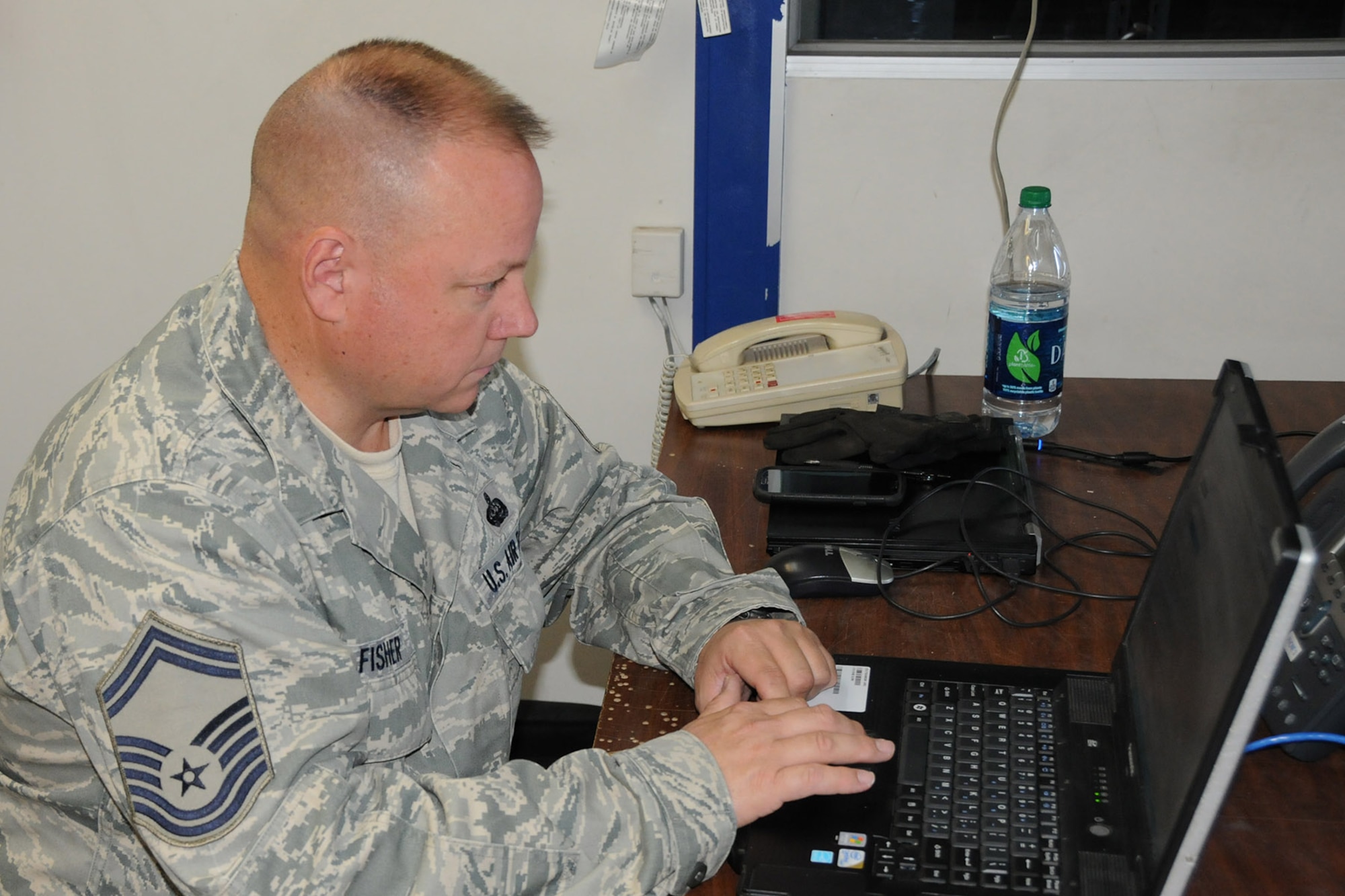Senior Master Sgt. Robert Fisher, 910th Communications Squadron (CS) Cyber Systems Superintendent, sets up a laptop computer in the 910th CS work center here, Sept. 16, 2014. A five-person 910th CS team is supporting a two-week aerial spray mission through a wide variety of technologies designed to keep all of the 910th’s Citizen Airmen in touch with each other and their home base of Youngstown Air Reserve Station, Ohio while performing their duty in Idaho. The 910th Airlift Wing, based at Youngstown Air Reserve Station, Ohio, is home to the Department of Defense’s only large-area, fixed-wing aerial spray capability. U.S. Air Force photo by Tech. Sgt. Rick Lisum