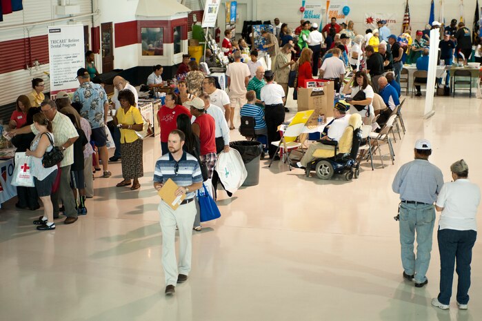 U.S. Armed Forces retirees and their families visit booths during a Retiree Appreciation Day information fair at Nellis Air Force Base, Nev., Sept. 13, 2014. The fair offered helpful services and information to retirees and their families. (U.S. Air Force photo by Senior Airman Timothy Young)