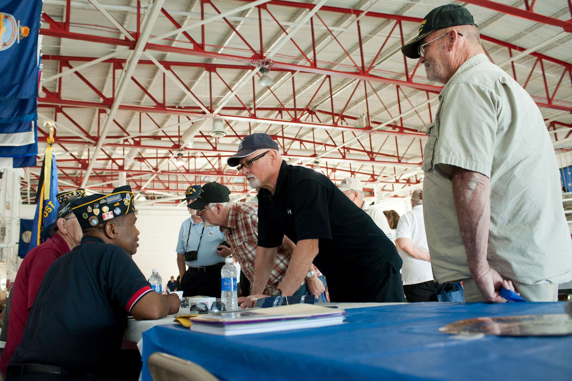 U.S. Armed Forces retirees share stories of prior service during a Retiree Appreciation Day information fair at Nellis Air Force Base, Nev., Sept. 13, 2014. The information fair included health-screening opportunities, educational consultants, banking information and other areas considered important to retirees. (U.S. Air Force photo by Senior Airman Timothy Young)