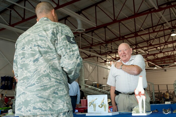 Retired U.S. Air Force Master Sgt. Harold Thompson discusses surgery options with U.S. Air Force Tech. Sgt. Jeremy Pearson, 99th Surgical Operations Squadron surgical technician, during Retiree Appreciation Day at Nellis Air Force Base, Nev., Sept. 13, 2014. Retirees of all military services and their guests were invited to attend the event. (U.S. Air Force photo by Senior Airman Timothy Young)