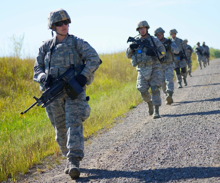 Senior Airman Beth Gehris and a team of 934th Security Forces Squadron members move into hostile territory during an exercise at Arden Hills Army Training Center Minn. Sept. 3. (Air Force Photo/Paul Zadach)
