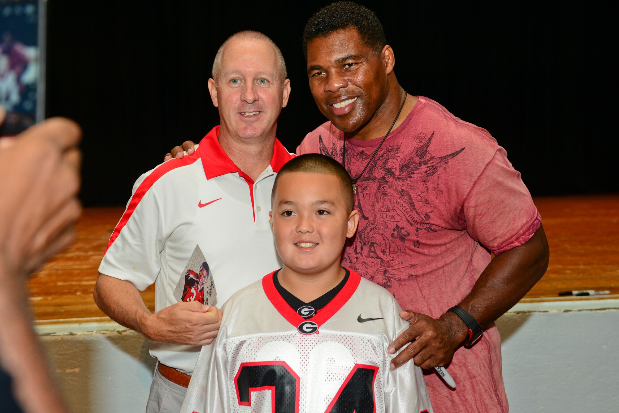 Andy and James Anderson, local U.S. Army retiree, meet Herschel Walker, Heisman Trophy recipient and mental health advocate, at Fort Eustis, Va., Sept. 16, 2014. Several veterans waited in line to take photos with Walker and receive his autograph. (U.S. Air Force photo by Airman 1st Class Kimberly Nagle/Released)
