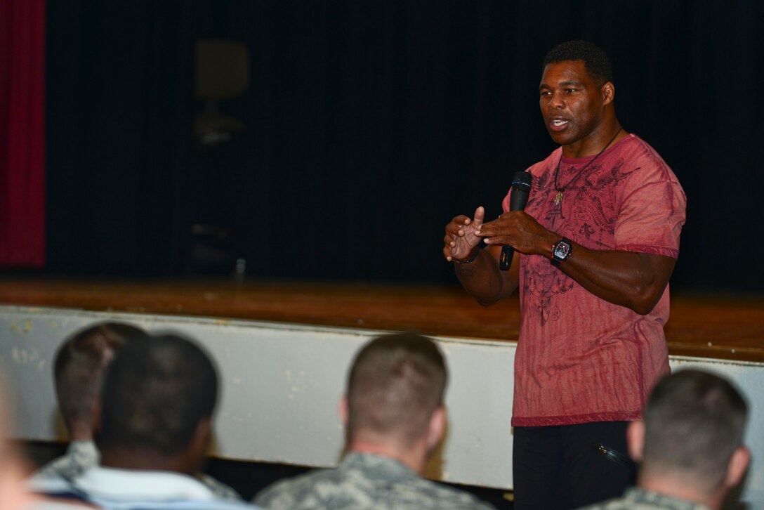 Herschel Walker, Heisman Trophy recipient and mental health advocate, speaks to a crowd at Fort Eustis, Va., Sept. 16, 2014. During his visit to Fort Eustis, Walker spoke about his football career and life with multiple personality disorder. (U.S. Air Force photo by Airman 1st Class Kimberly Nagle/Released)
