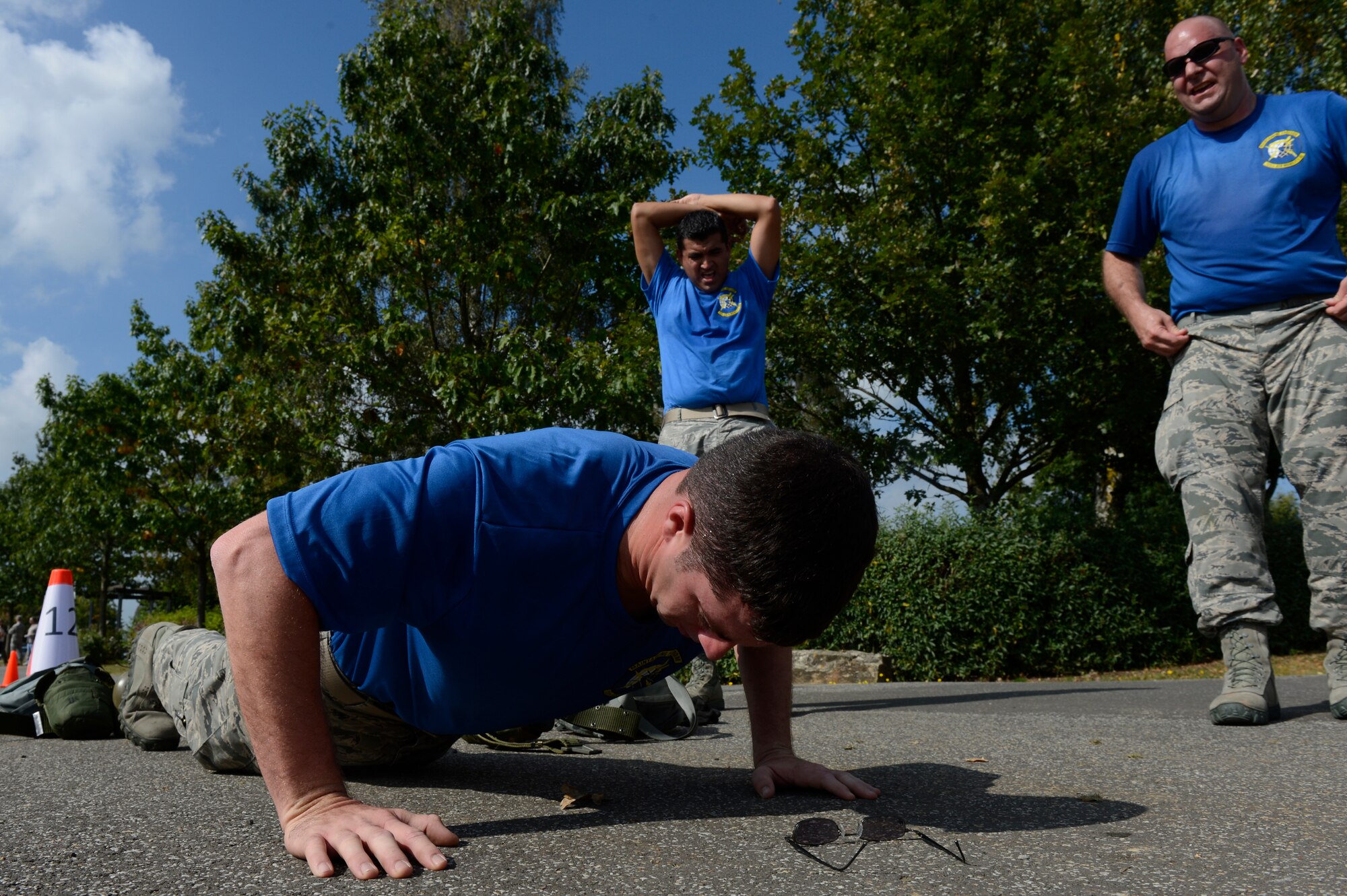 U.S. Air Force Staff Sgt. Johnathan Mansel, 725th Air Mobility Squadron hydraulics technician and native of New Albany, Miss., rotates among his team members to perform 521 pushups during the 521st Air Mobility Operations Wing Round Up obstacle course held at Spangdahlem Air Base, Germany, Sept. 16, 2014. The 725th AMS is located in Rota, Spain. Several bases from U.S. Air Forces in Europe and Air Forces Africa participated in the competition. (U.S. Air Force photo by Staff Sgt. Christopher Ruano/Released)