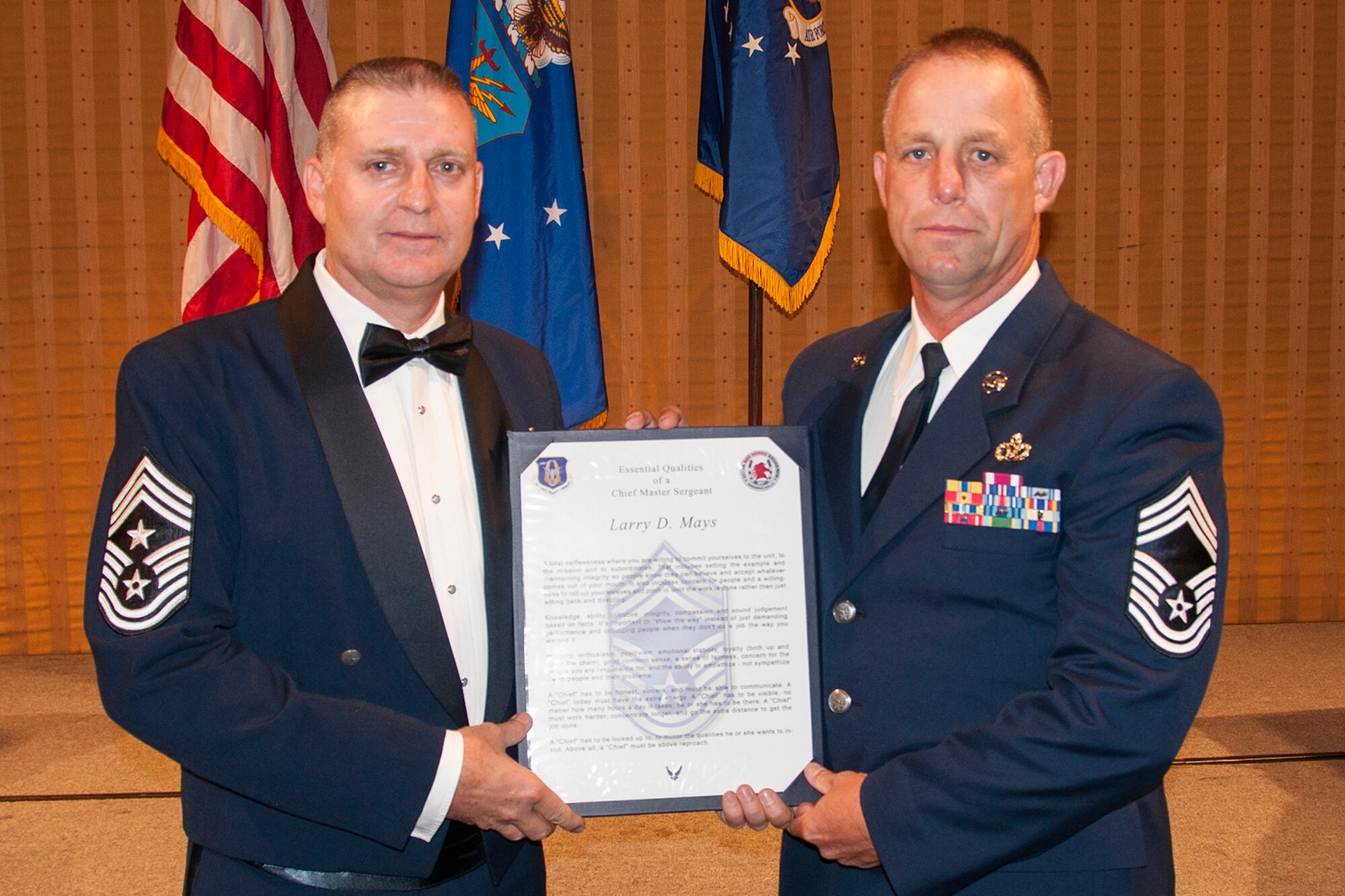 U.S. Air Force Chief Master Sgt. Larry Mays (right) is recognized during the 307th Bomb Wing Senior Noncommissioned Officer Induction Ceremony, Sept. 6, 2014, Bossier City, La. The ceremony is an annual event held to recognize Airmen who were recently promoted to the ranks of Chief Master Sergeant and Master Sergeant. (U.S. Air Force photo by Tech. Sgt. Ted Daigle/Released)