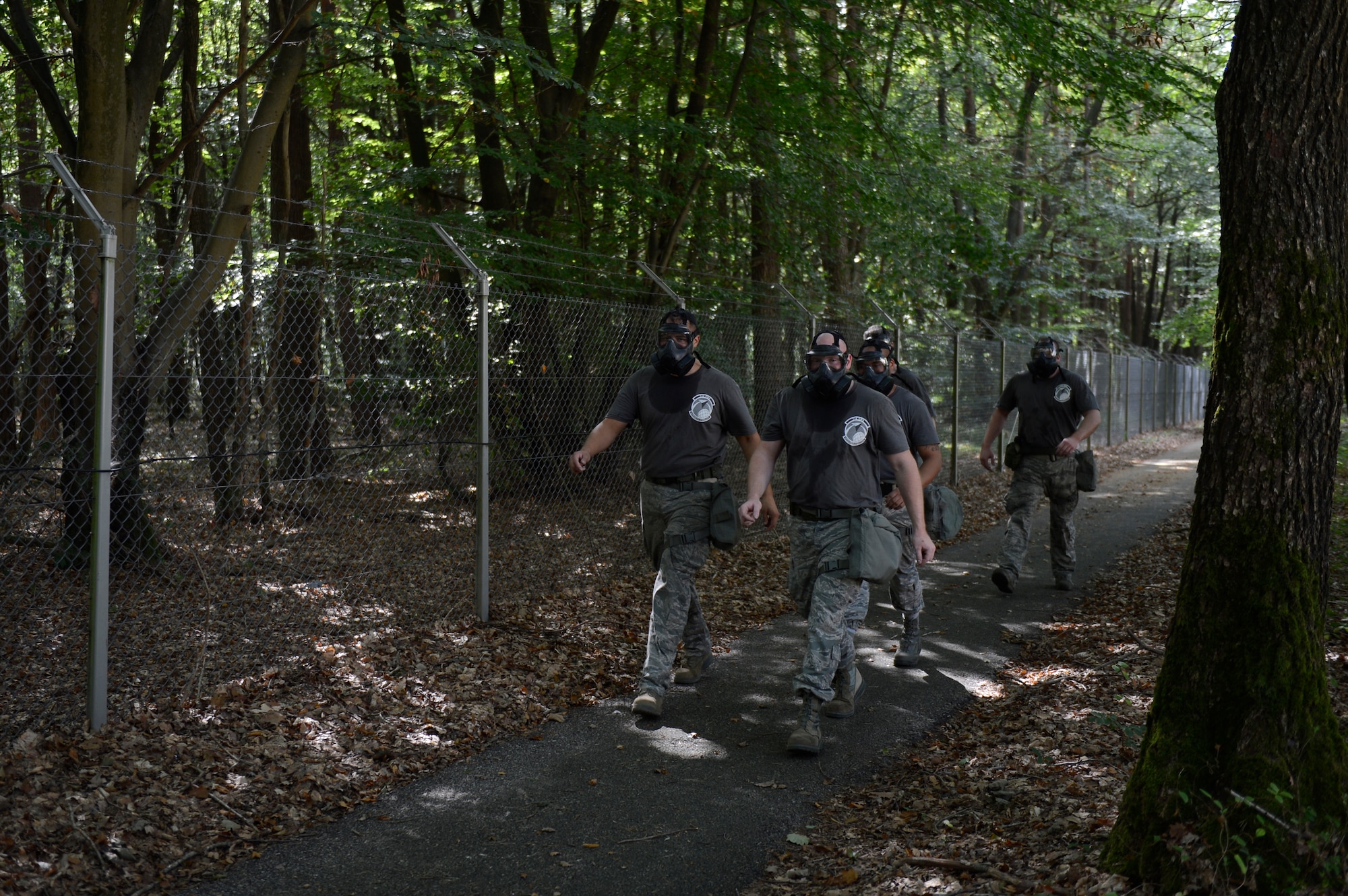 Service members form the 726th Air Mobility Squadron team don gas masks during the 521st Air Mobility Operations Wing Round Up obstacle course held at Spangdahlem Air Base, Germany, Sept. 16, 2014. In the maintenance category the 721st Aircraft Maintenance Squadron from Ramstein Air Base, Germany won first place. (U.S. Air Force photo by Staff Sgt. Christopher Ruano/Released)