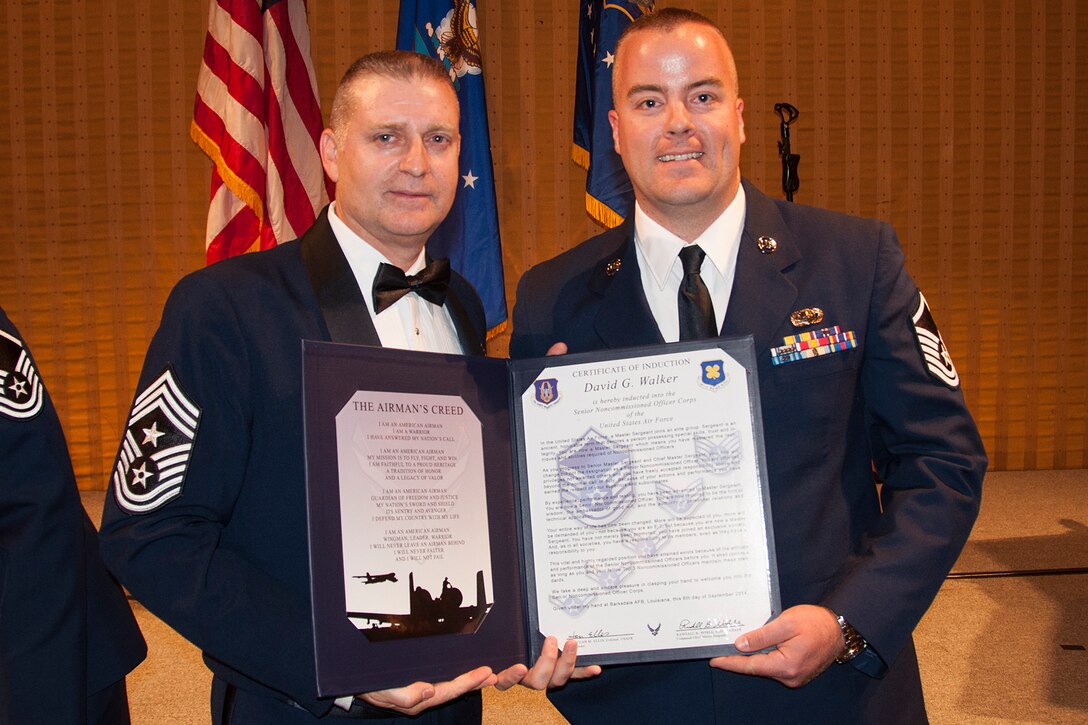 U.S. Air Force Master Sgt. David Walker is presented the Certificate of Induction during a ceremony on Sept. 6, 2014, Bossier City, La. The 307th Bomb Wing Senior Noncommissioned Officer Induction Ceremony is an annual event held to recognize Airmen who were recently promoted to the rank of Master Sergeant. (U.S. Air Force photo by Tech. Sgt. Ted Daigle/Released)