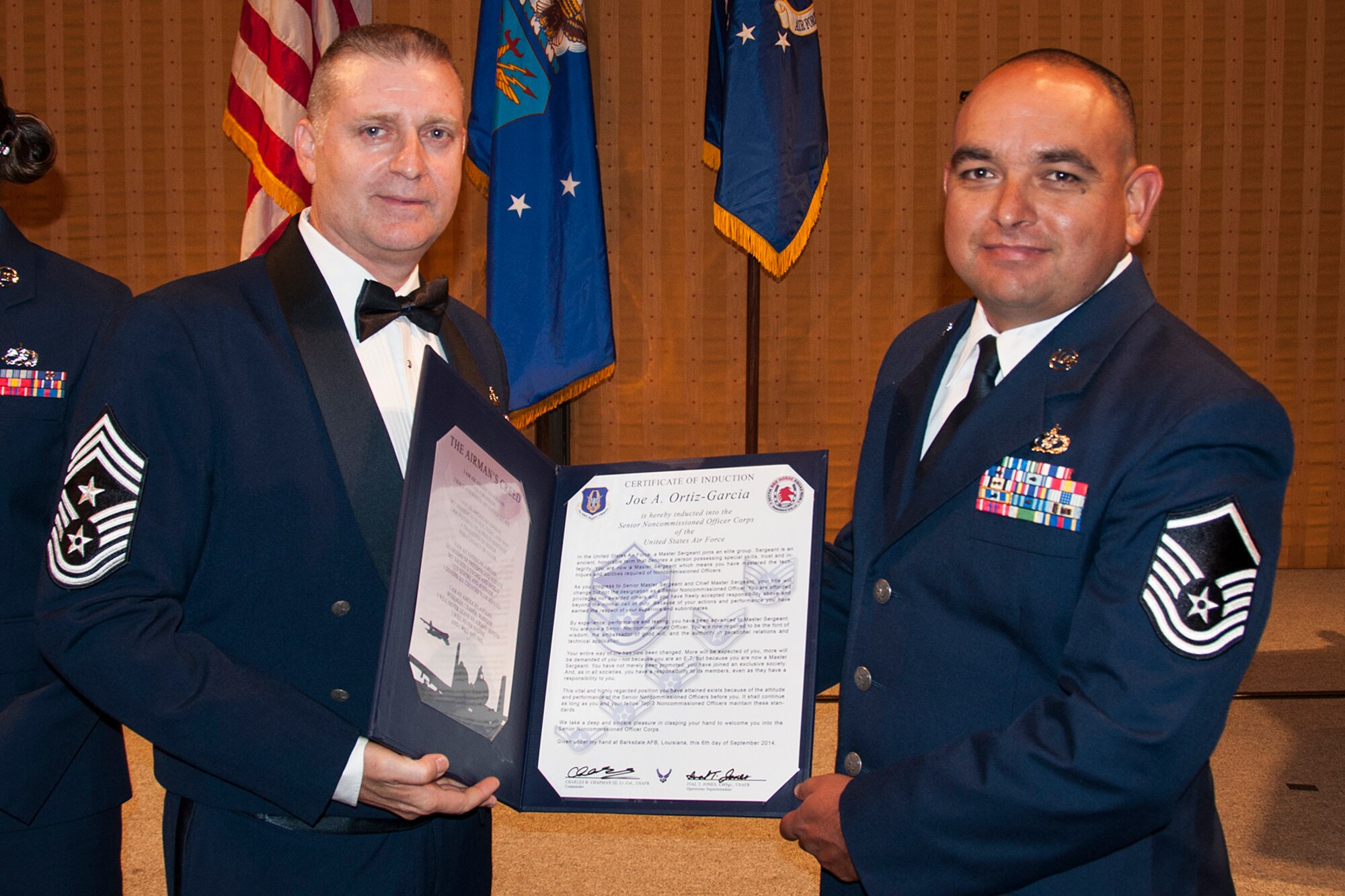 U.S. Air Force Master Sgt. Joe Ortiz-Garcia is presented the Certificate of Induction during a ceremony on Sept. 6, 2014, Bossier City, La. The 307th Bomb Wing Senior Noncommissioned Officer Induction Ceremony is an annual event held to recognize Airmen who were recently promoted to the rank of Master Sergeant. (U.S. Air Force photo by Tech. Sgt. Ted Daigle/Released)