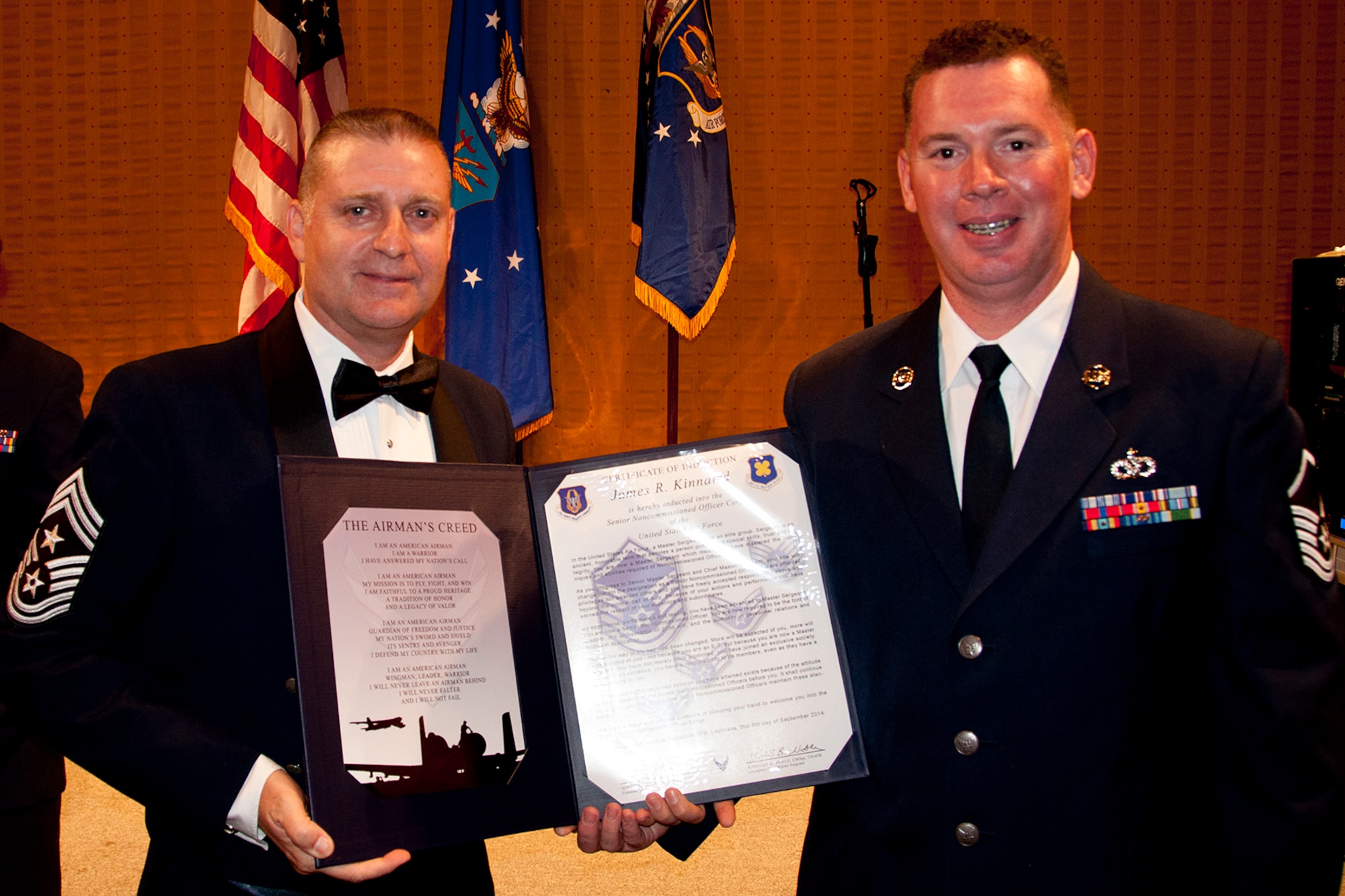U.S. Air Force Master Sgt. James Kinnaird is presented the Certificate of Induction during a ceremony on Sept. 6, 2014, Bossier City, La. The 307th Bomb Wing Senior Noncommissioned Officer Induction Ceremony is an annual event held to recognize Airmen who were recently promoted to the rank of Master Sergeant. (U.S. Air Force photo by Tech. Sgt. Ted Daigle/Released)