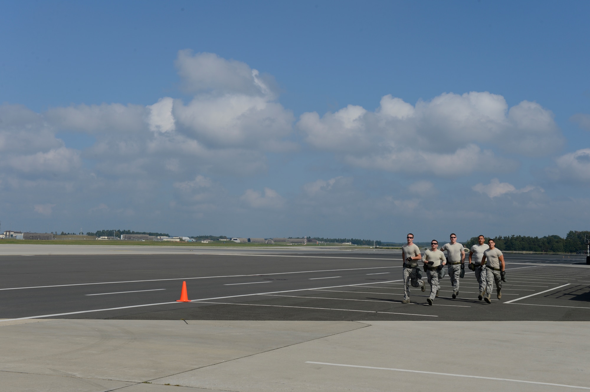 The 724th Air Mobility Squadron from Aviano Air Base, Italy, run to the next obstacle during the 521st Air Mobility Operations Wing Round Up obstacle course held at Spangdahlem Air Base, Germany, Sept. 16, 2014. Obstacles included running 3-mile, flipping tires and stacking dunnage obstacle, to name a few along the course. (U.S. Air Force photo by Staff Sgt. Christopher Ruano/Released)