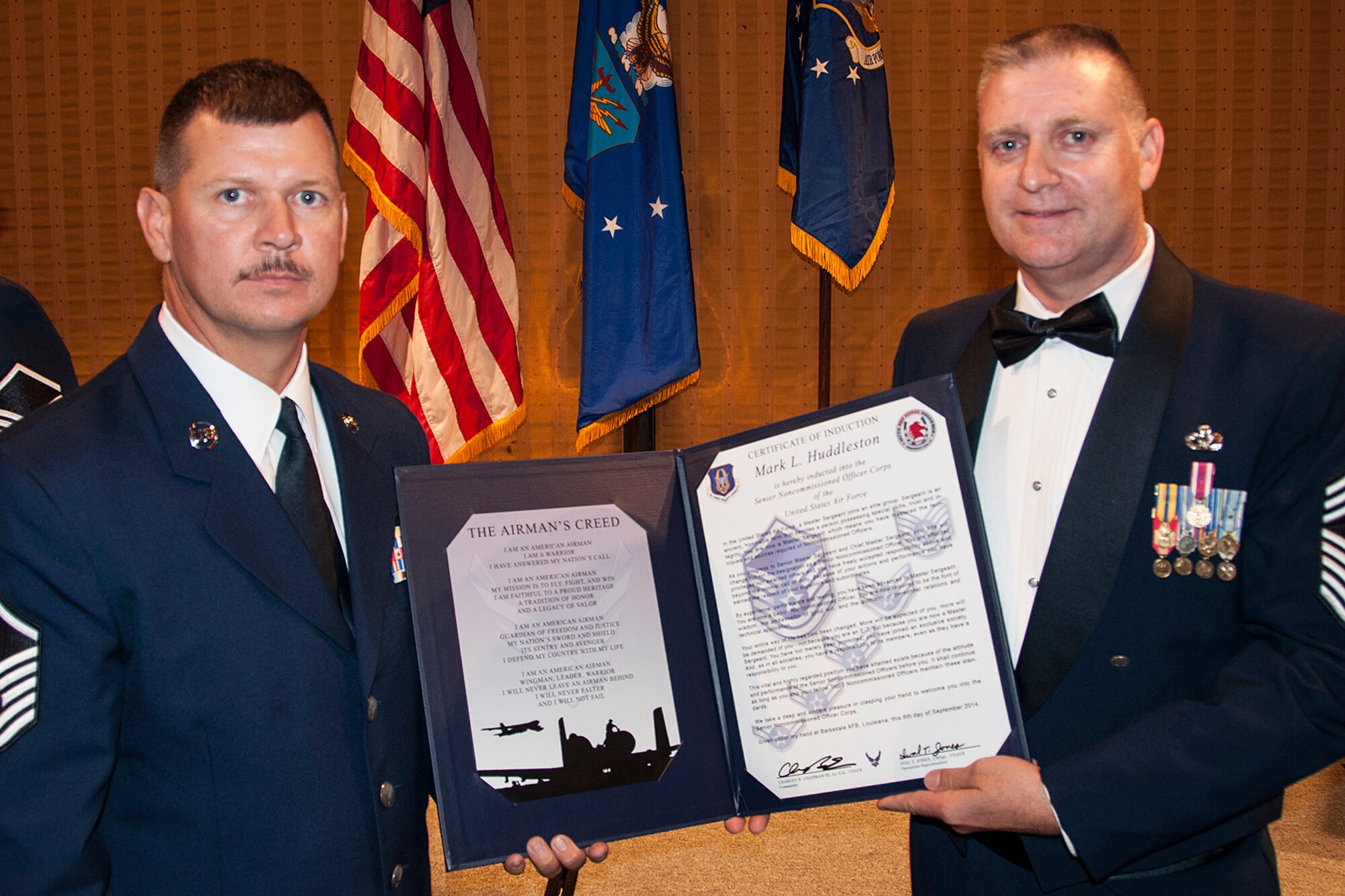 U.S. Air Force Master Sgt. Mark Huddleston is presented the Certificate of Induction during a ceremony on Sept. 6, 2014, Bossier City, La. The 307th Bomb Wing Senior Noncommissioned Officer Induction Ceremony is an annual event held to recognize Airmen who were recently promoted to the rank of Master Sergeant. (U.S. Air Force photo by Tech. Sgt. Ted Daigle/Released)