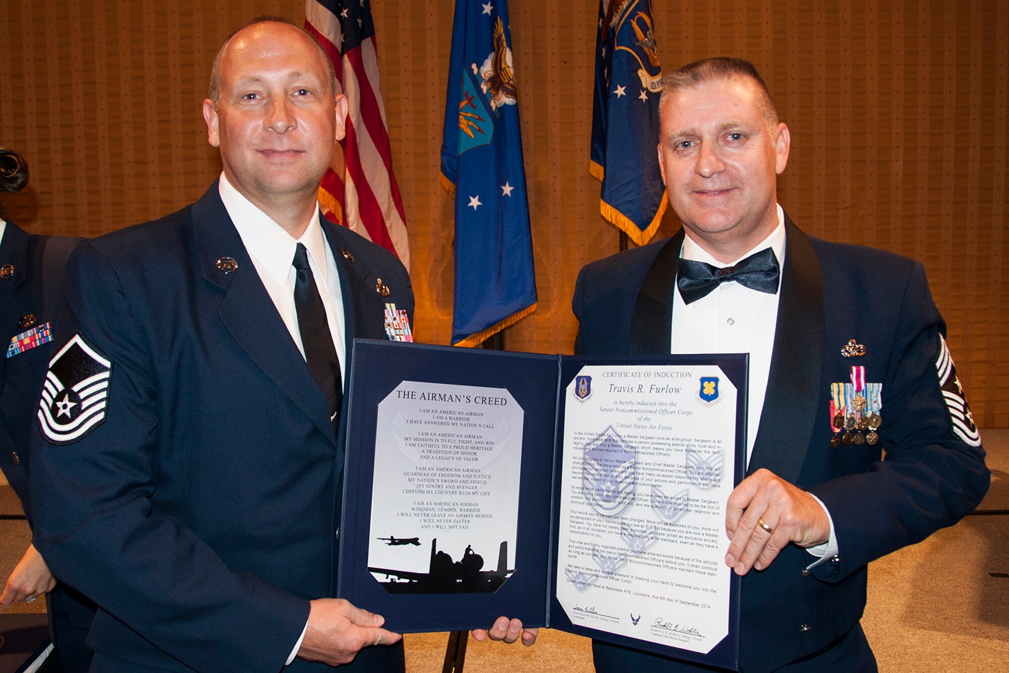 U.S. Air Force Master Sgt. Travis Furlow is presented the Certificate of Induction during a ceremony on Sept. 6, 2014, Bossier City, La. The 307th Bomb Wing Senior Noncommissioned Officer Induction Ceremony is an annual event held to recognize Airmen who were recently promoted to the rank of Master Sergeant. (U.S. Air Force photo by Tech. Sgt. Ted Daigle/Released)