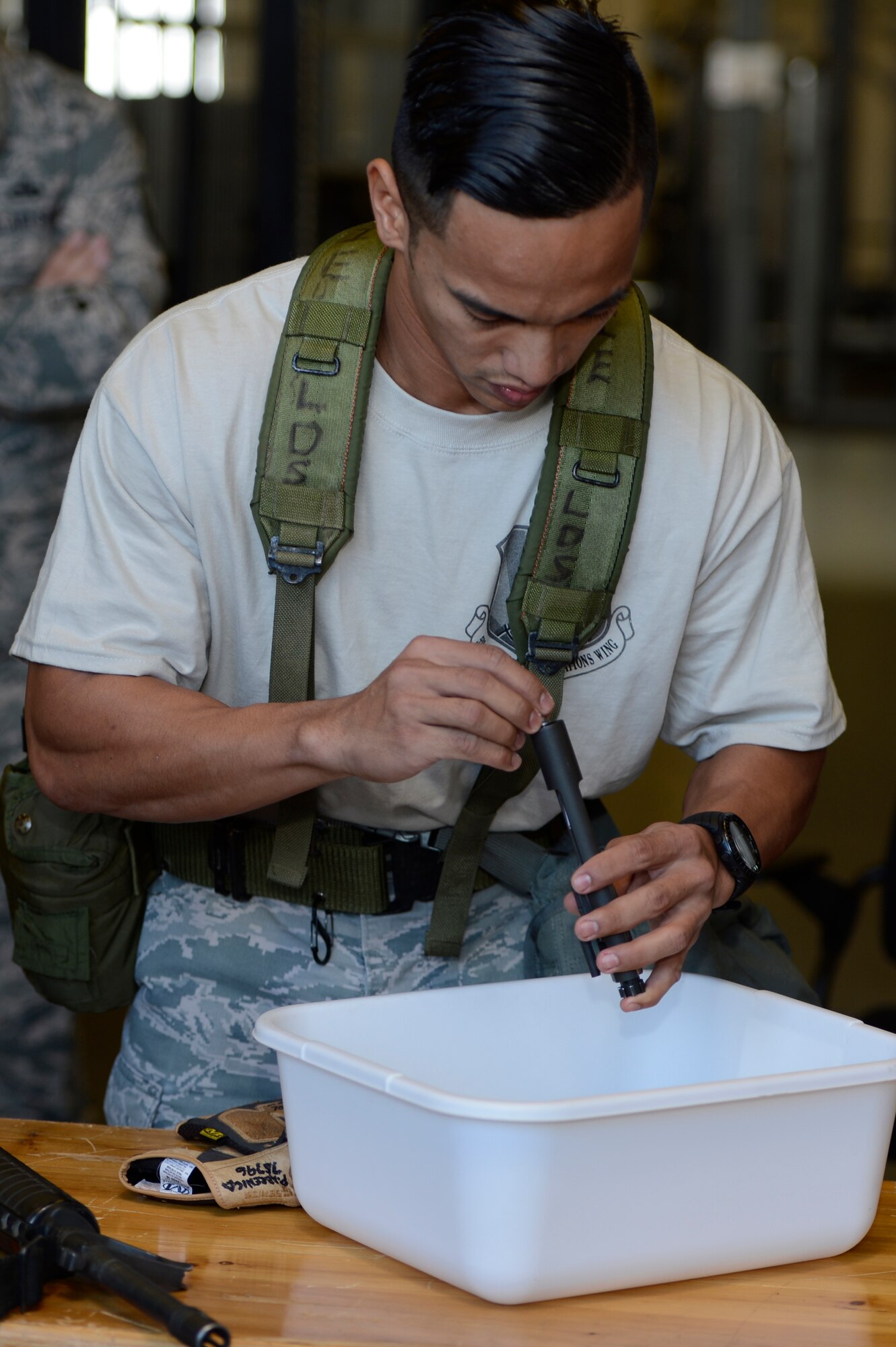 U.S. Air Force Senior Airman Patrik Abrewica, 726th Air Mobility Squadron air terminal operations center controller and native from Monroe Township, N.J., assembles an M-16 rifle during the 521st Air Mobility Operations Wing Round Up obstacle course held at Spangdahlem Air Base, Germany, Sept. 16, 2014. The event ended with a barbecue and award presentation. (U.S. Air Force photo by Staff Sgt. Christopher Ruano/Released)