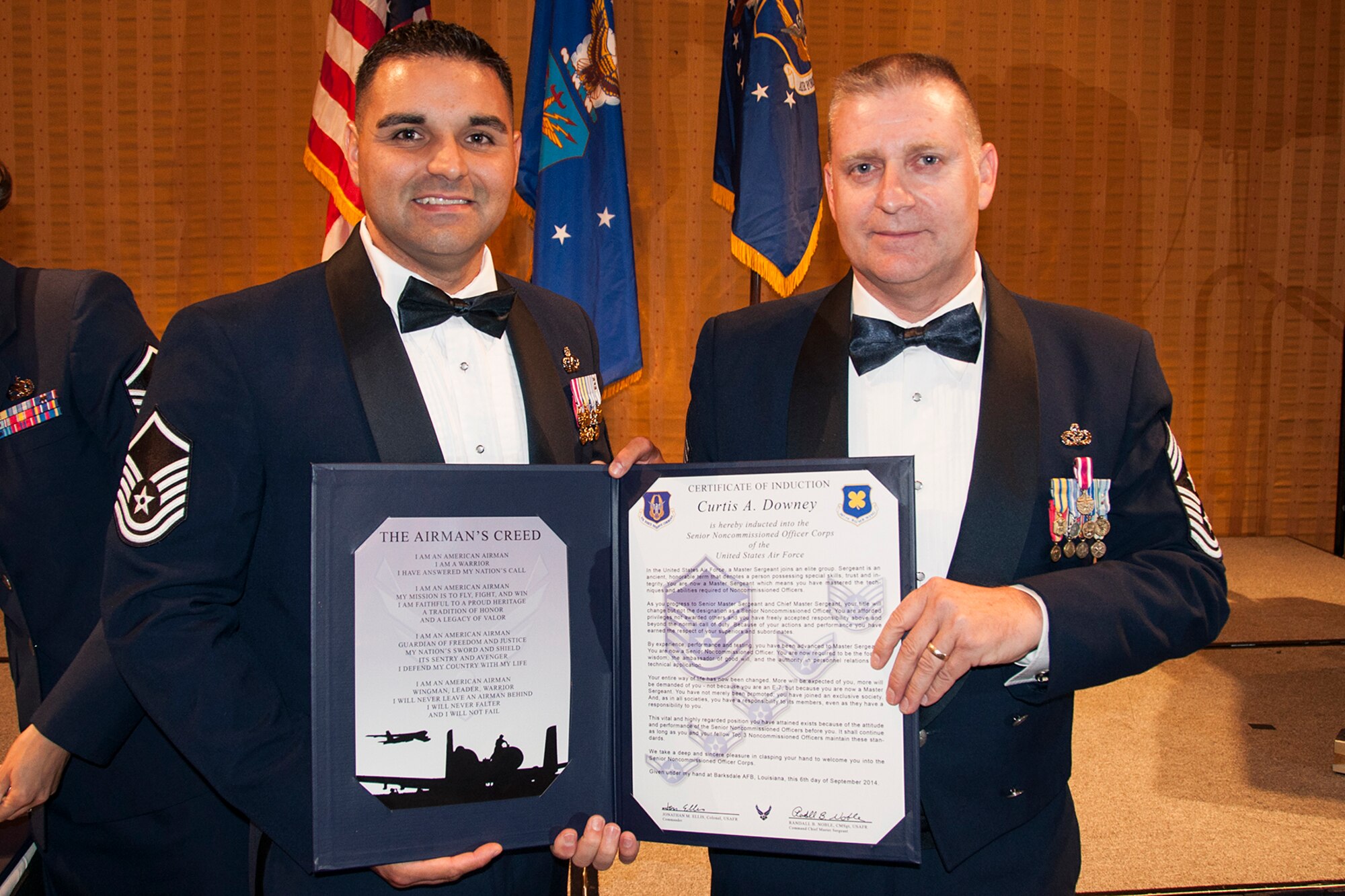 U.S. Air Force Master Sgt. Curtis Downey is presented the Certificate of Induction during a ceremony on Sept. 6, 2014, Bossier City, La. The 307th Bomb Wing Senior Noncommissioned Officer Induction Ceremony is an annual event held to recognize Airmen who were recently promoted to the rank of Master Sergeant. (U.S. Air Force photo by Tech. Sgt. Ted Daigle/Released)