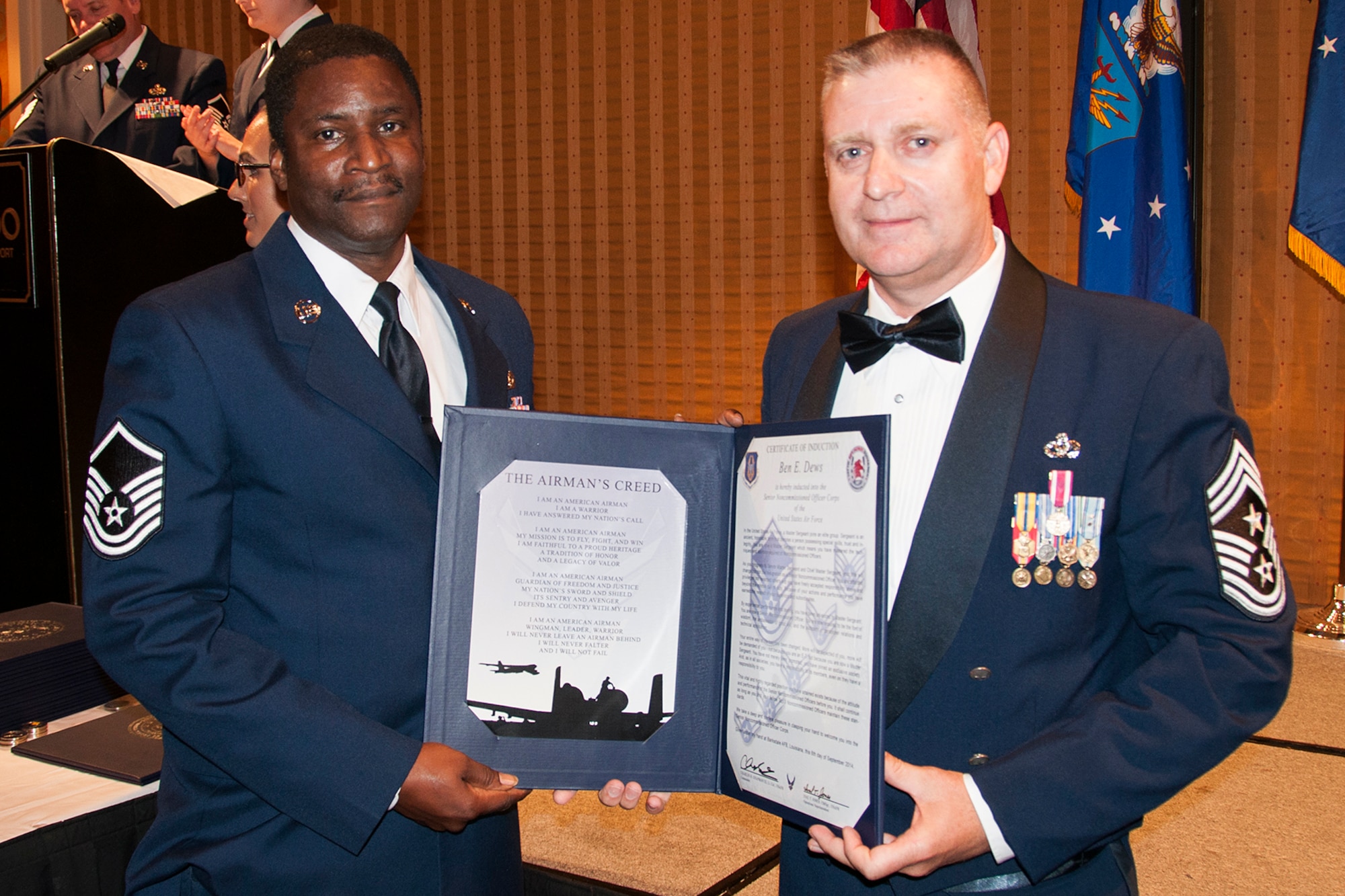 U.S. Air Force Master Sgt. Ben Dews is presented the Certificate of Induction during a ceremony on Sept. 6, 2014, Bossier City, La. The 307th Bomb Wing Senior Noncommissioned Officer Induction Ceremony is an annual event held to recognize Airmen who were recently promoted to the rank of Master Sergeant. (U.S. Air Force photo by Tech. Sgt. Ted Daigle/Released)
