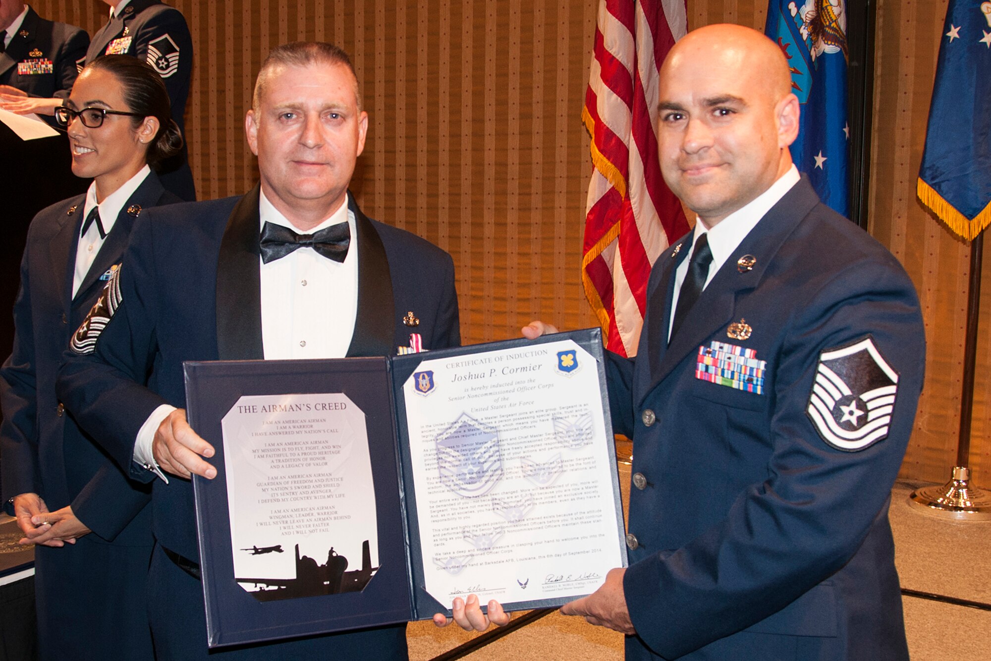 U.S. Air Force Master Sgt. Joshua Cormier is presented the Certificate of Induction during a ceremony on Sept. 6, 2014, Bossier City, La. The 307th Bomb Wing Senior Noncommissioned Officer Induction Ceremony is an annual event held to recognize Airmen who were recently promoted to the rank of Master Sergeant. (U.S. Air Force photo by Tech. Sgt. Ted Daigle/Released)