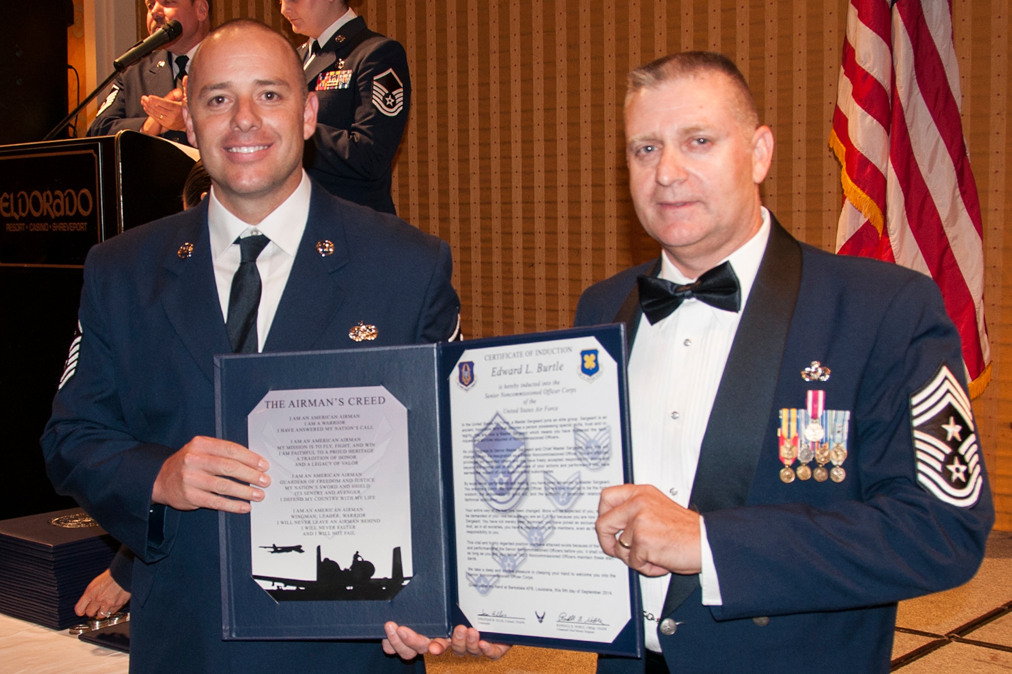 U.S. Air Force Master Sgt. Edward Burtle is presented the Certificate of Induction during a ceremony on Sept. 6, 2014, Bossier City, La. The 307th Bomb Wing Senior Noncommissioned Officer Induction Ceremony is an annual event held to recognize Airmen who were recently promoted to the rank of Master Sergeant. (U.S. Air Force photo by Tech. Sgt. Ted Daigle/Released)
