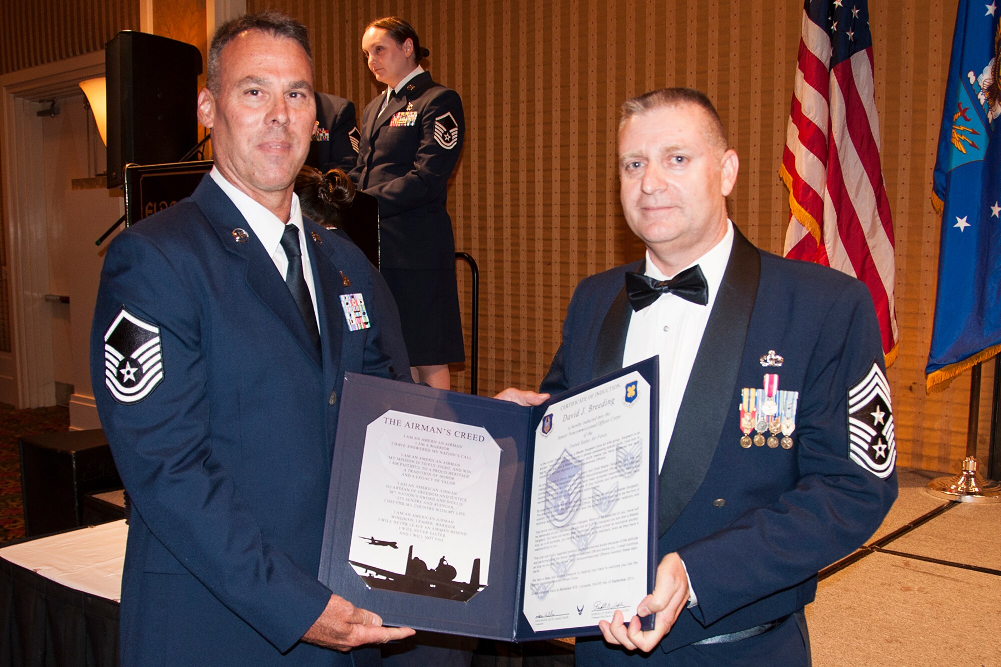 U.S. Air Force Master Sgt. David Breeding is presented the Certificate of Induction during a ceremony on Sept. 6, 2014, Bossier City, La. The 307th Bomb Wing Senior Noncommissioned Officer Induction Ceremony is an annual event held to recognize Airmen who were recently promoted to the rank of Master Sergeant. (U.S. Air Force photo by Tech. Sgt. Ted Daigle/Released)
