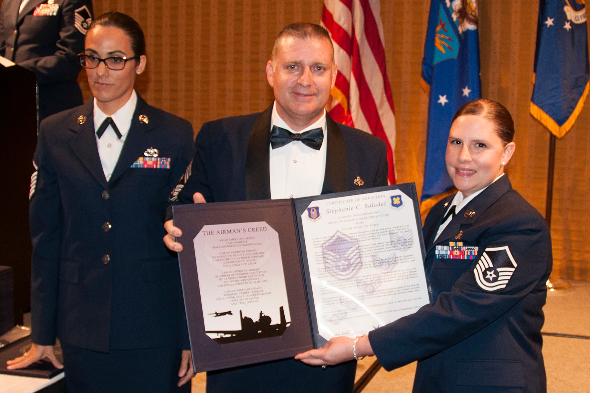 U.S. Air Force Master Sgt. Stephanie Baladez is presented the Certificate of Induction during a ceremony on Sept. 6, 2014, Bossier City, La. The 307th Bomb Wing Senior Noncommissioned Officer Induction Ceremony is an annual event held to recognize Airmen who were recently promoted to the rank of Master Sergeant. (U.S. Air Force photo by Tech. Sgt. Ted Daigle/Released)