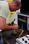 Staff Sgt. Nick Buck, 341st Maintenance Operations Squadron electronics laboratory team member, uses a multimeter to check the voltage of a guidance and control chiller test set during a training session at Malmstrom Air Force Base Aug. 25. Buck is testing the equipment as part of his training for the 2014 Global Strike Challenge. (U.S. Air Force photo/Airman 1st Class Collin Schmidt)
