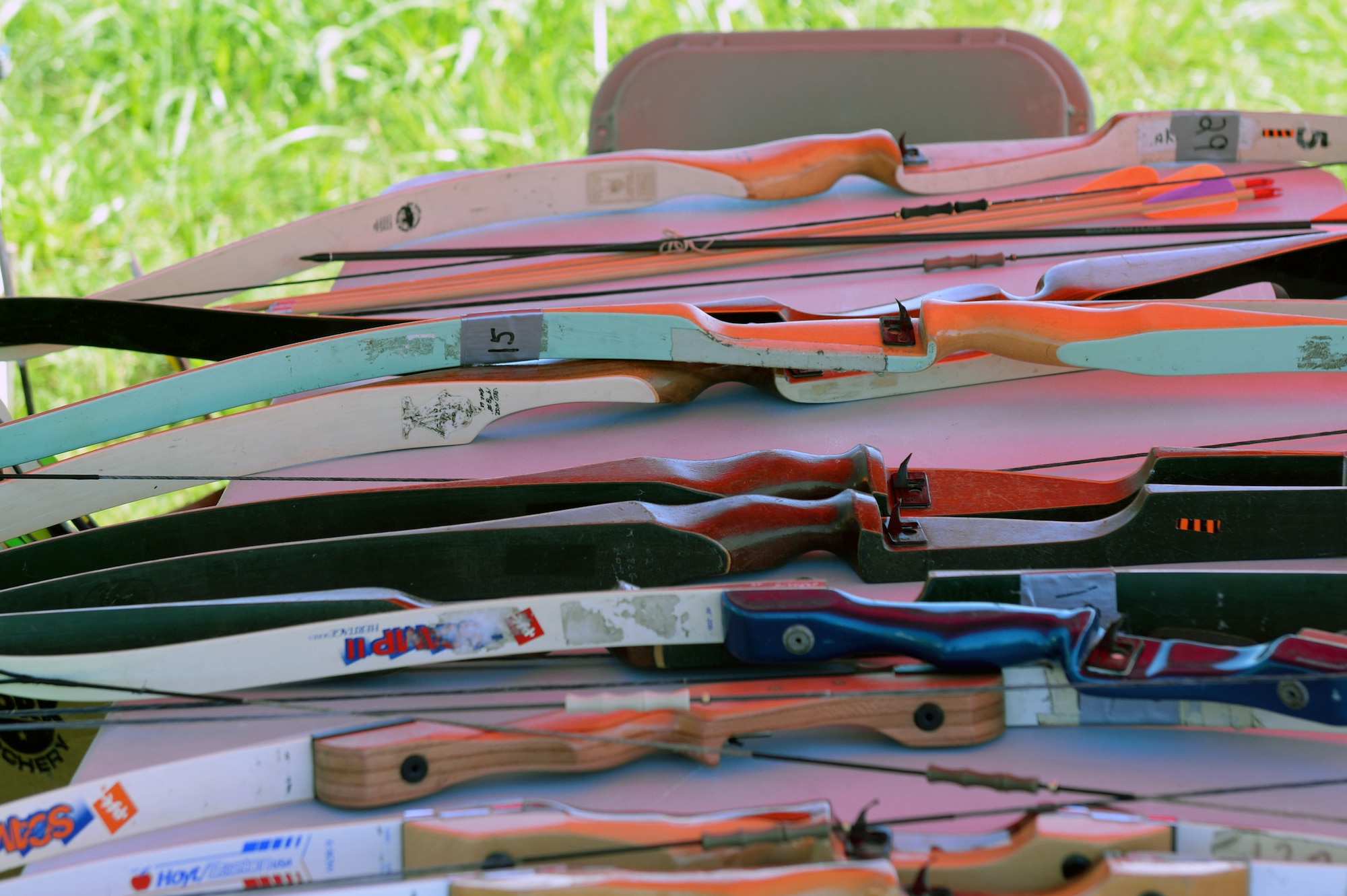 Recurve bows are piled during an archery tournament at Scott Air Force Base, Ill., Sept. 14, 2014. The event was hosted by Scott AFB Outdoor Recreation and had around two dozen participants. Four age categories allowed people of all ages and levels of expertise to compete. The archery range was rebuilt by Jack Hilbing, an Eagle Scout, a few years ago. (U.S. Air Force photo by Airman 1st Class Erica Crossen)