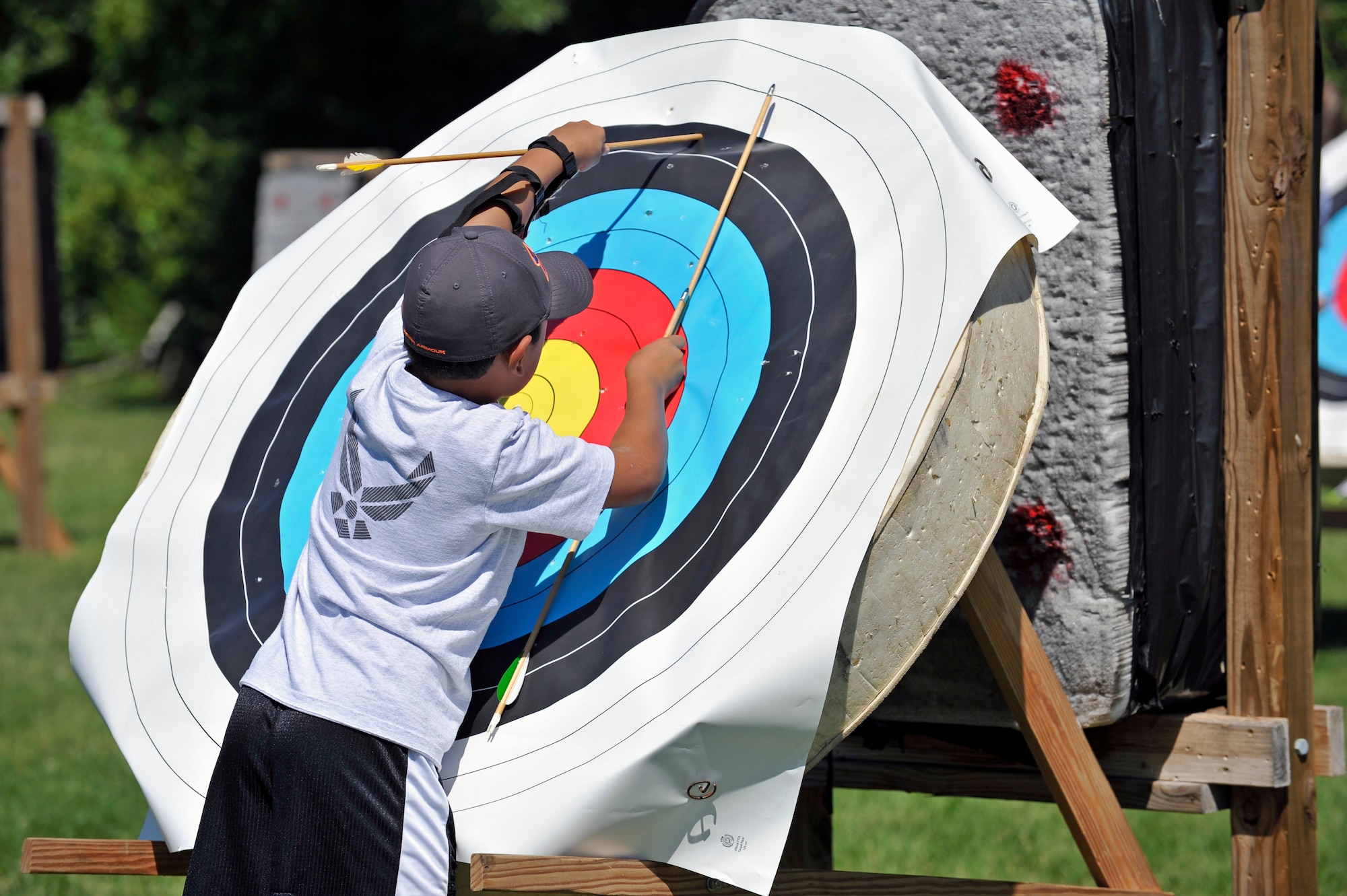 A young competitor at the archery range retrieves his arrow from the target during an archery tournament at Scott Air Force Base, Ill., Sept. 14, 2014. The event was hosted by Scott AFB Outdoor Recreation and had around two dozen participants. There were categories for youth, teen, young adult and adult winners. The archery range was rebuilt by an Eagle Scout a few years ago. (U.S. Air Force photo by Airman 1st Class Erica Crossen)