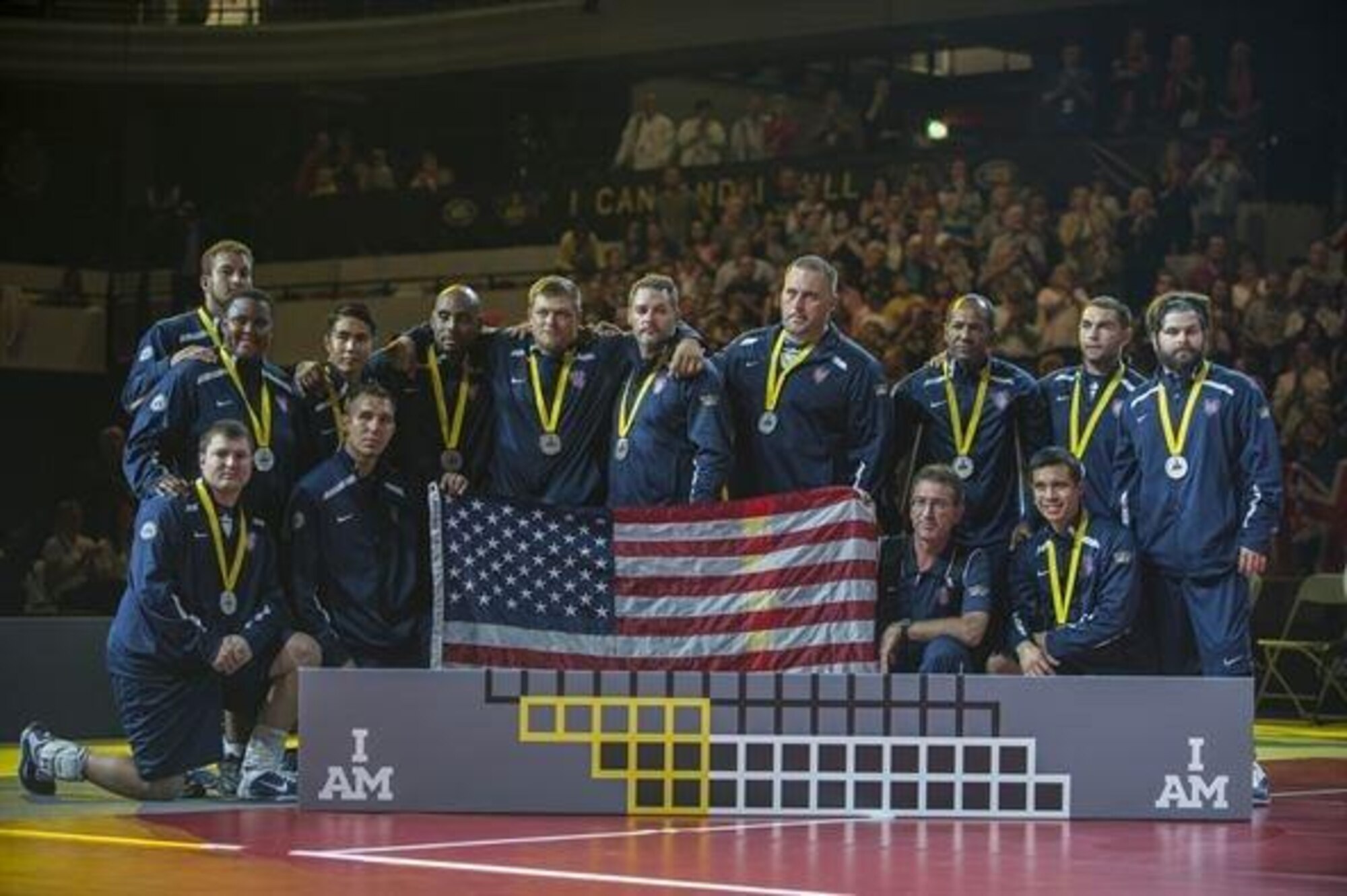 The USA Team poses for a picture as they placed second in the sitting volleyball finals at the Invictus Games Sept. 14, 2014, in London. Great Britain defeated the U.S. in a best-out-of-five match. The Invictus Games featured athletes competing in various Paralympic-style events, including swimming, track and field, seated volleyball, wheelchair basketball, and wheelchair rugby, among others. (U.S. Navy photo/Mass Communication Specialist 1st Class (SW) Mark Logico)
