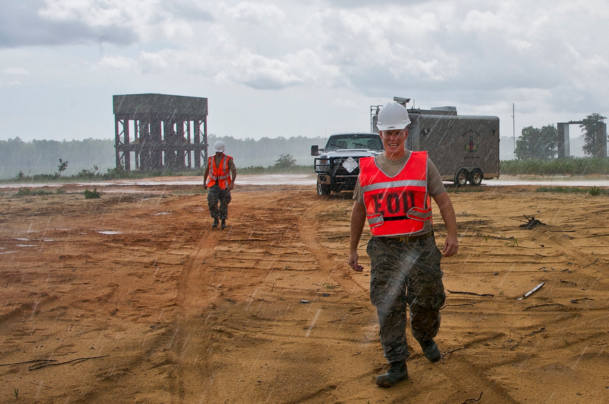 Staff Sgt. Brian Westgate, 96th Civil Engineer Squadron explosive ordnance disposal robotics technician returns to the test site where a robot he remotely controlled completed its mission of retrieving a test item Sept. 9 on Eglin’s range. He is a member of the Air Force’s only EOD robotics team who developed a plan for retrieving a buried test item and safely extracting the fuze using remotely-operated vehicles. (U.S. Air Force photo/Chrissy Cuttita)