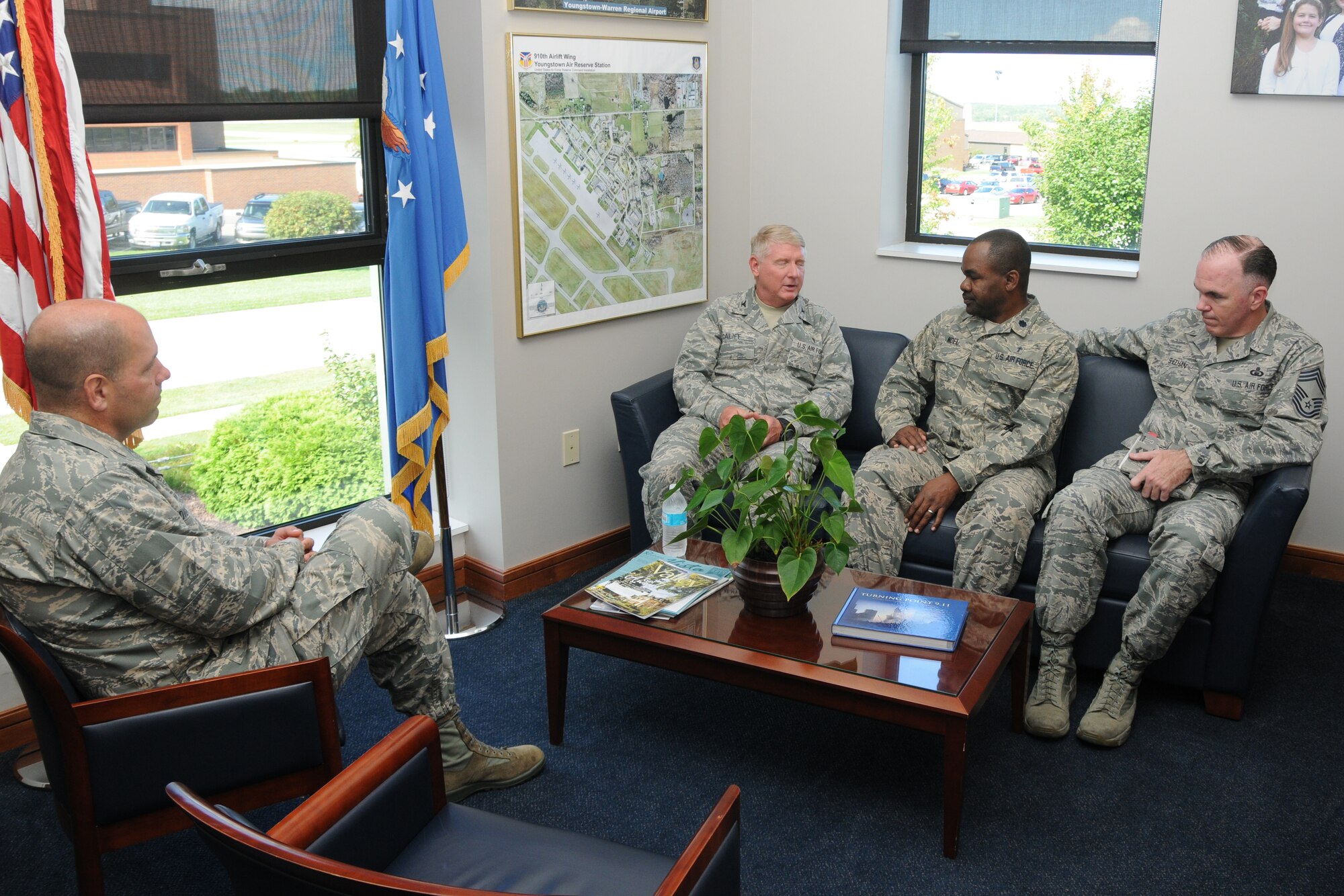 Col. James Dignan, 910th Airlift Wing commander, talks with Chaplain (Col.) Gary R. Califf, Command Chaplain of the Air Force Reserve, in the 910th Airlift Wing headquarters building here, Sept. 7, 2014. Califf visited Youngstown Air Reserve Station during the Sept. Unit Training Assemble. Also present are Chaplain (Lt. Col.) Klavens Noel, 910th Airlift Wing chaplain, and Chief Master Sgt. Walter Sheehan, Air Force Reserve Command chaplain assistant functional manager. U.S. Air Force photo/Tech. Sgt. Jim Brock.  