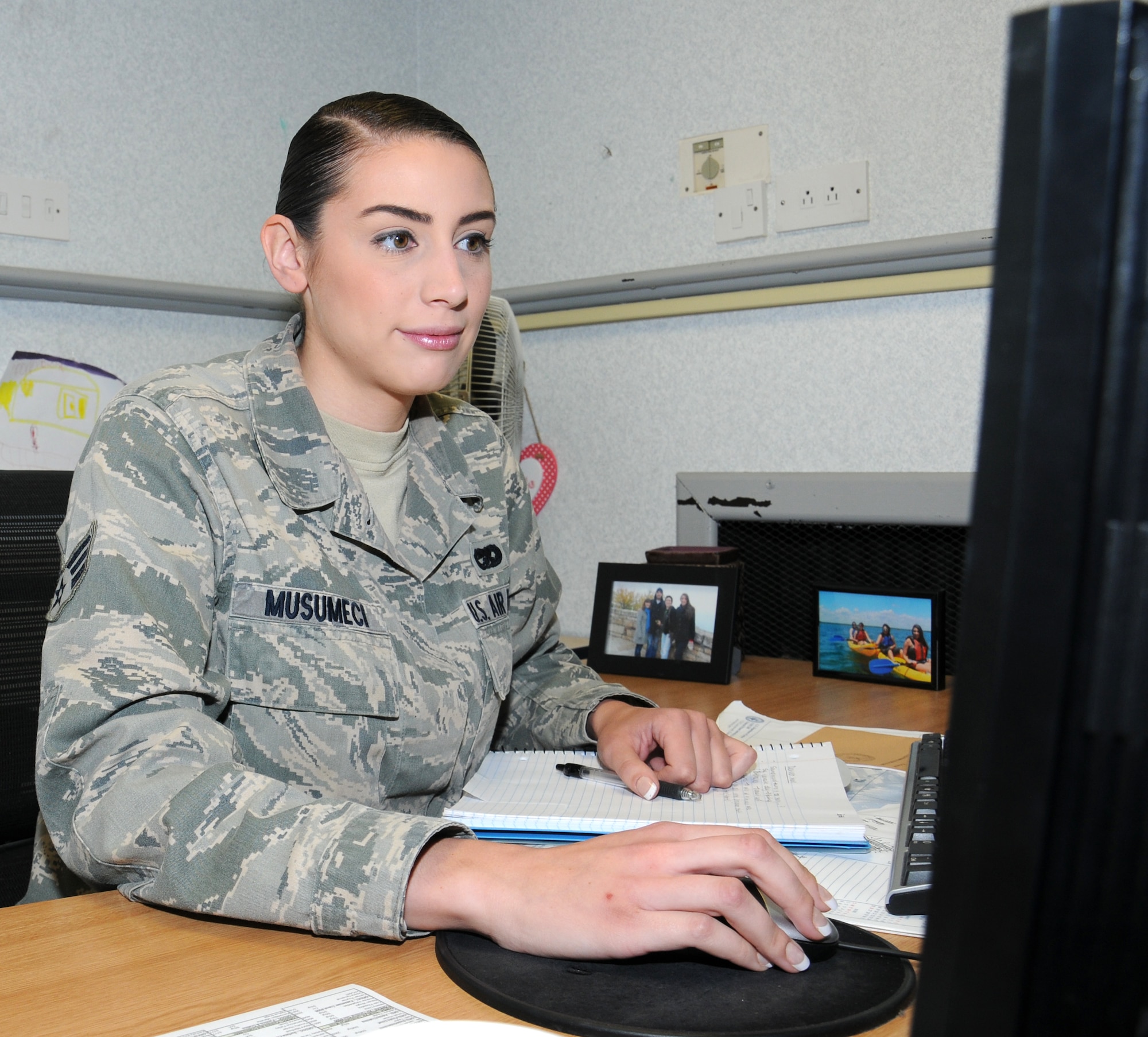 U.S. Air Force Senior Airman Alexis Musumeci, 100th Logistics Readiness Squadron commander’s executive from Oregon, Wis., tracks an enlisted performance report Sept. 2, 2014, on RAF Mildenhall, England. The commander’s support staff tracks EPRs and officer performance reports, runs the drug demand reduction urinalysis program for the unit and also tracks fitness testing. (U.S. Air Force photo/Gina Randall/Released)