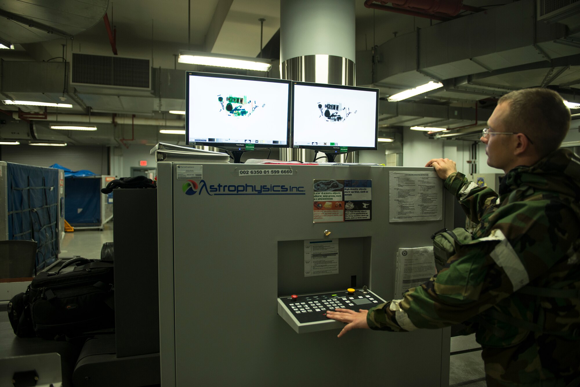 Senior Airman Thomas Mclure, a 731st Air Mobility Squadron passenger service assistant supervisor, at Osan Air Base, Republic of Korea, scans a bag on an X-ray machine Sept. 17, 2014. Mclure works at the Osan AB PAX terminal, where approximately 400-500 bags are scanned per day. (U.S. Air Force photo by Staff Sgt. Jake Barreiro