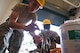 U.S. Air Force Airman 1st Class Jonathan Tuxbury, left, and Senior Airman Charles Agyemang, both from the Massachusetts Air National Guard's 212th Engineering Installation Squadron, prepare wiring for a job, Sept. 9, 2014, at Atlantic City Air National Guard base, N.J. (U.S. Air National Guard photo by Tech. Sgt. Matt Hecht/Released)