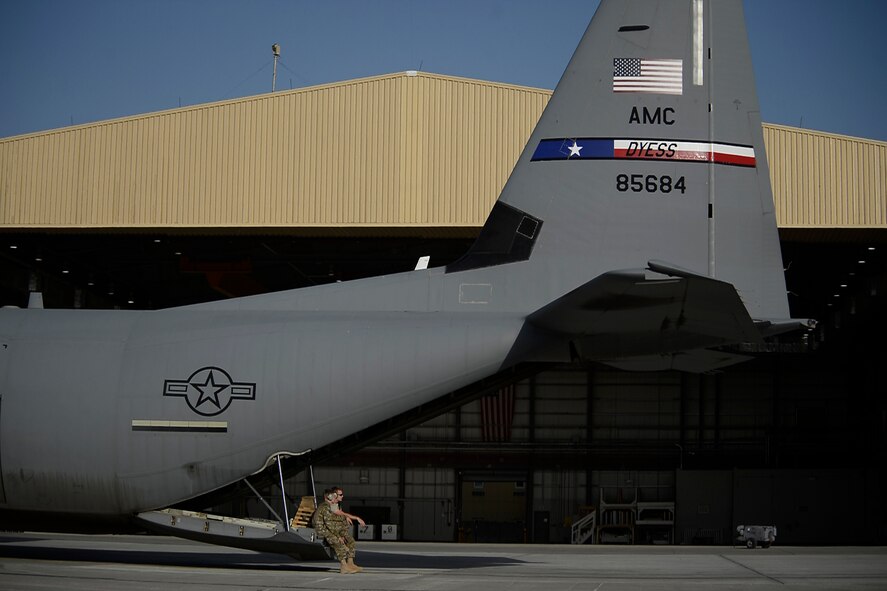 U.S. Air Force Airmen with the 774th Expeditionary Airlift Squadron, sit on the back of a C-130J Super Hercules aircraft at Bagram Airfield, Afghanistan Sept. 12, 2014.  The unit redeployed to their home base Dyess Air Force Base, Texas.  The 41st Airlift Squadron from Little Rock, Arkansas replaced the unit. The 774 EAS supported various tactical airlift capabilities including airdrop operations as well as humanitarian efforts and aeromedical evacuation.  (U.S. Air Force photo by Staff Sgt. Evelyn Chavez/Released)