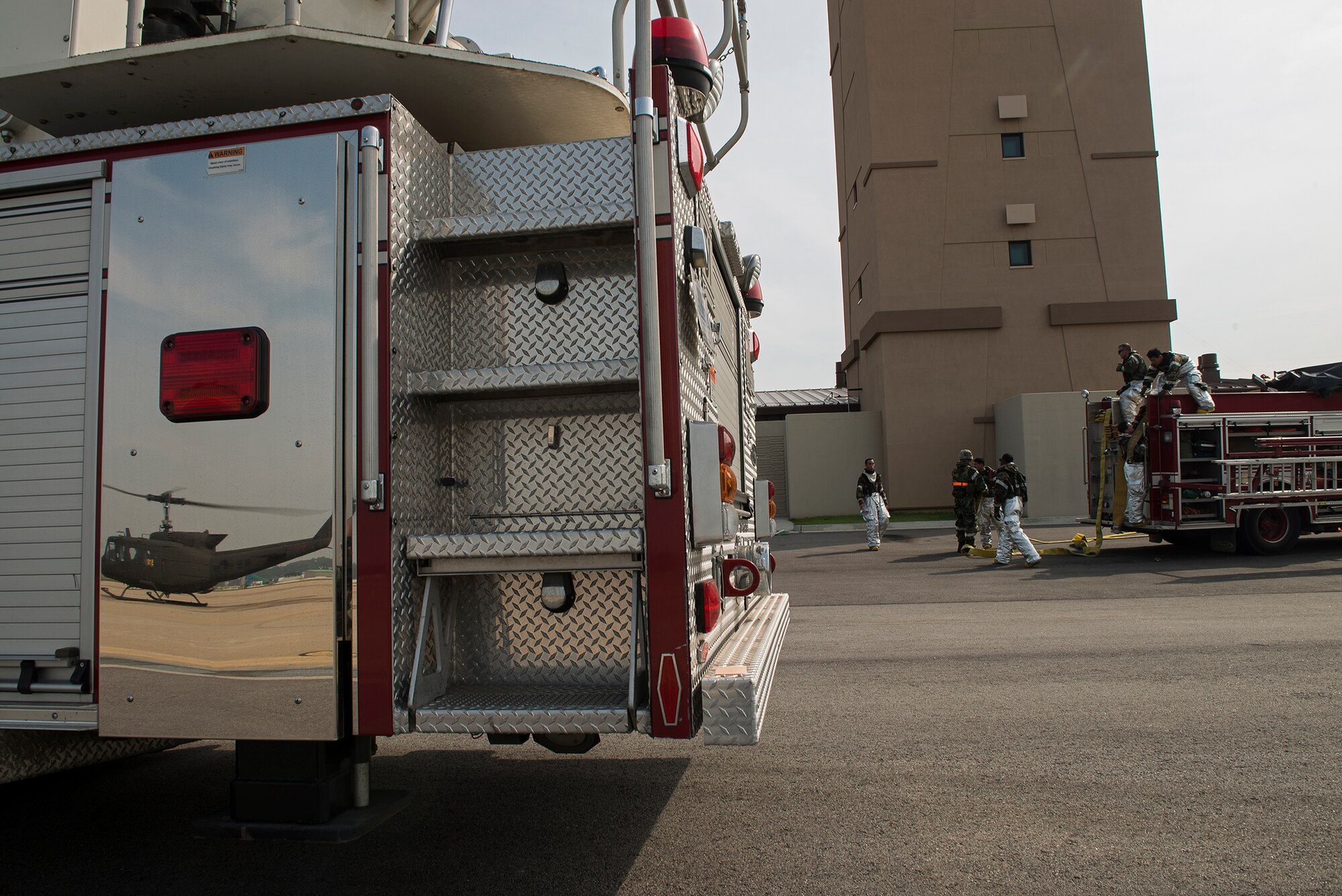 Firefighters from the 51st Civil Engineer Squadron pack up their equipment after completing a fire  training scenario Sept. 16, 2014, at Osan Air Base, Republic of Korea. The firedepartment was being inspected during Operational Readiness Exercise Beverly Midnight 14-4, designed to test the base's joint operability, command and control and bedown procedures. (U.S. Air Force photo by Staff Sgt. Jake Barreiro)