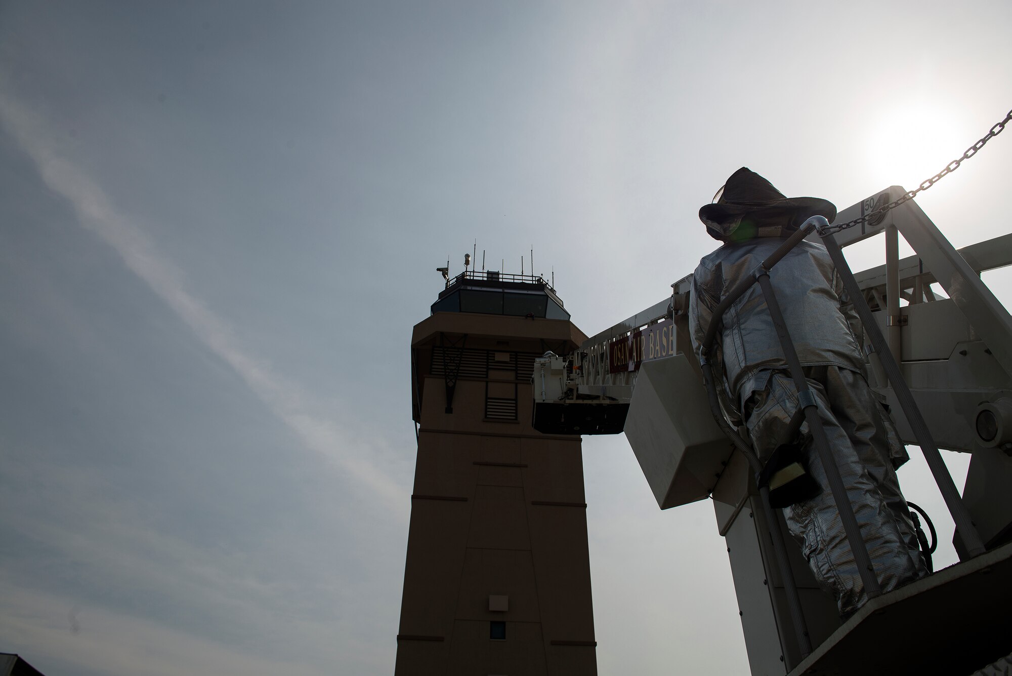 Senior Airman John Duncan, 51st Civil Engineer Squadron firefighting technician, operates a mechanical ladder during a fire scenario Sept. 16, 2014, at Osan Air Base, Republic of Korea. The scenario involved a simulated victim being trapped atop the Air Traffic Control Tower, and the Fire Department saving them. (U.S. Air Force photo by Staff Sgt. Jake Barreiro)