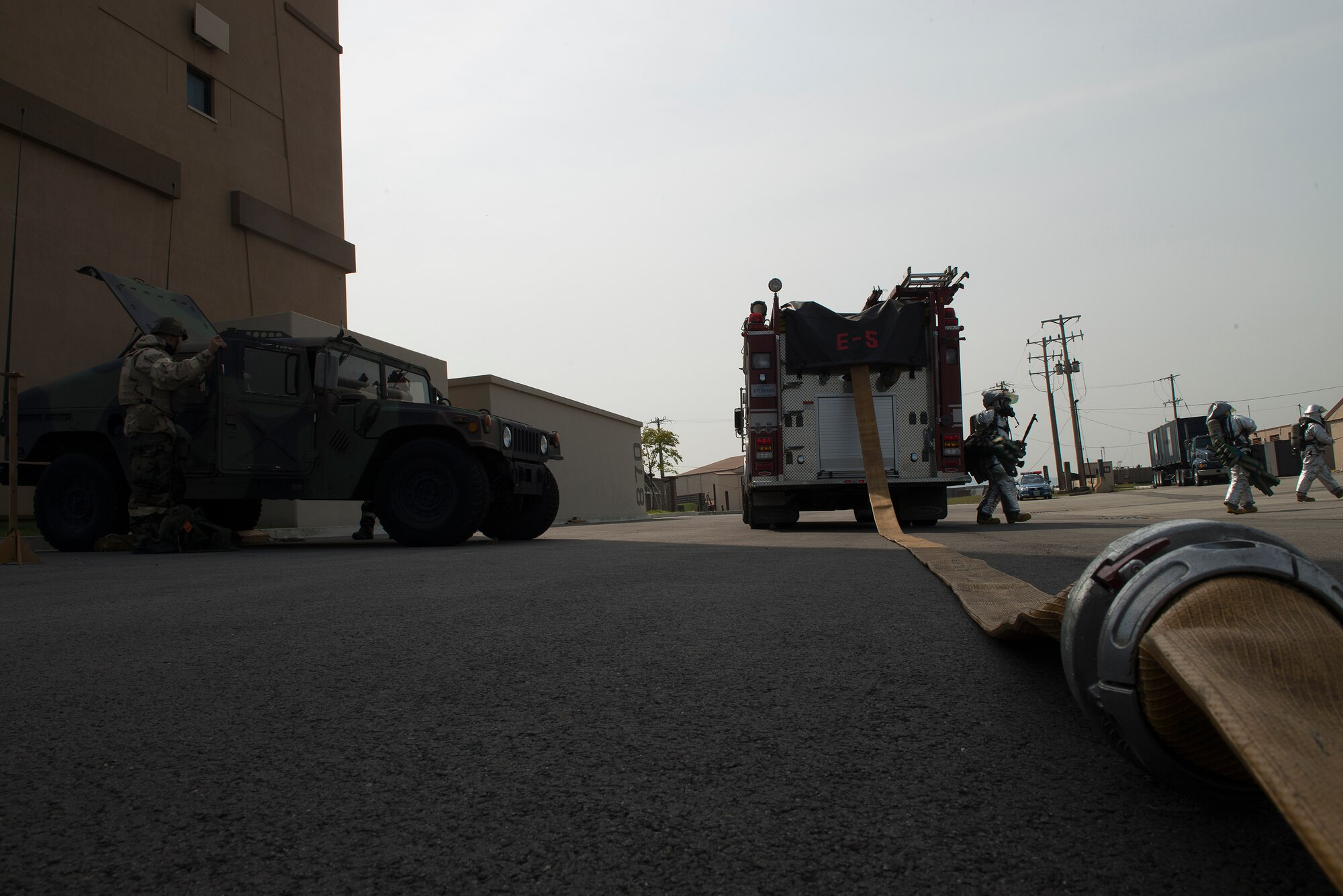 Firefighters from the 51st Civil Engineer Squadron prepare to enter the Air Traffic Control tower during a fire-scenario Sept. 16, 2014, at Osan Air Base, Republic of Korea. Beverly Midnight 14-4 is designed to test the joint operatability of Team Osan and its partners. (U.S. Air Force photo by Staff Sgt. Jake Barreiro)