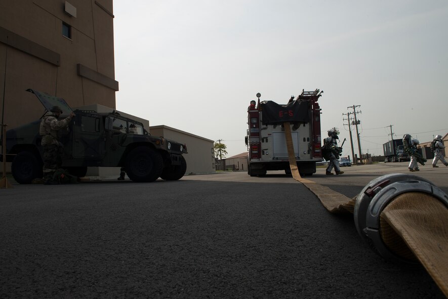 Firefighters from the 51st Civil Engineer Squadron prepare to enter the Air Traffic Control tower during a fire-scenario Sept. 16, 2014, at Osan Air Base, Republic of Korea. Beverly Midnight 14-4 is designed to test the joint operatability of Team Osan and its partners. (U.S. Air Force photo by Staff Sgt. Jake Barreiro)