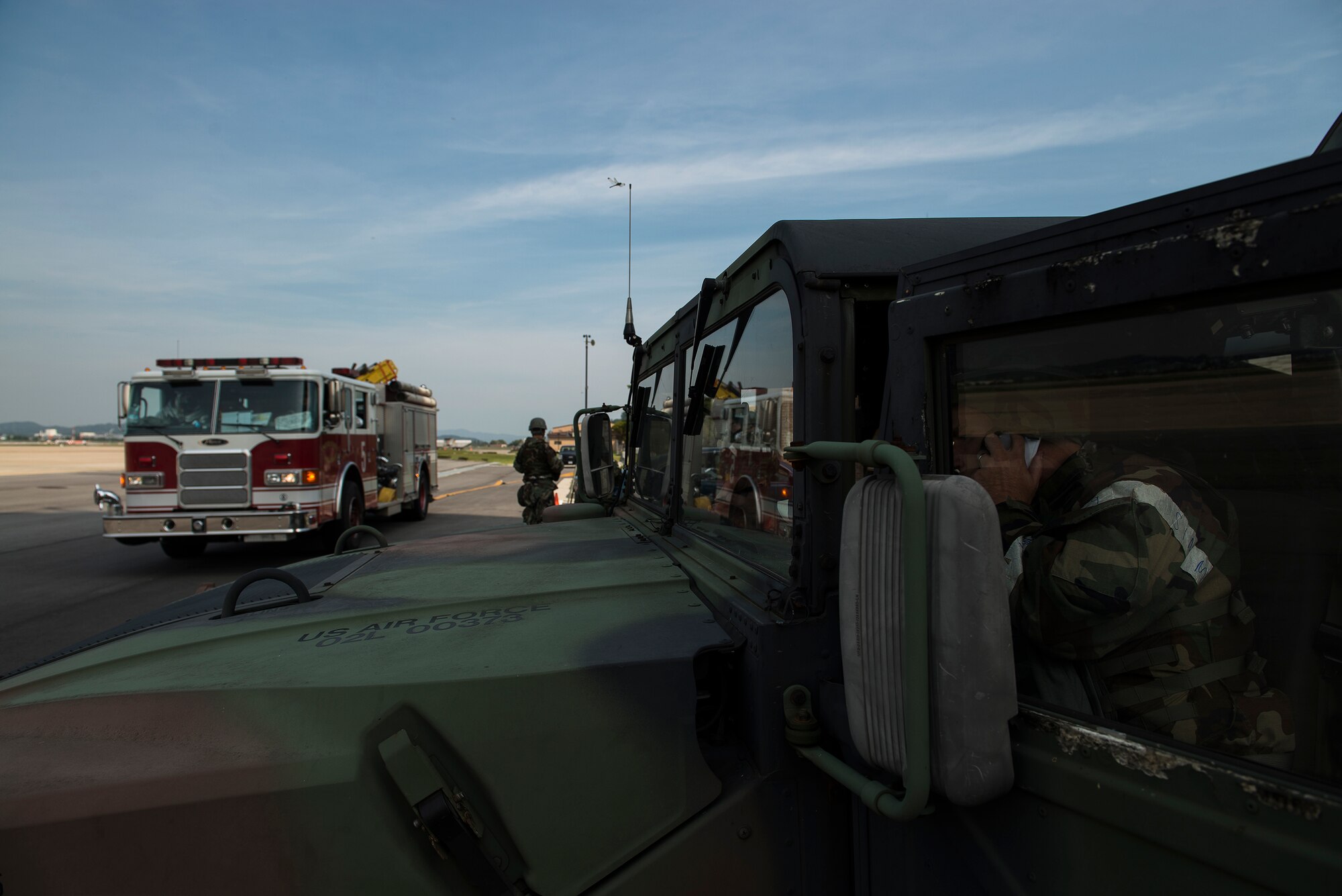 Firefighters from the 51st Civil Engineer Squadron arrive on the scene during a fire-scenario exercise Sept. 16, 2014, at Osan Air Base, Republic of Korea. The scenario was part of Operational Readiness Exercise Beverly Midnight 14-4. (U.S. Air Force photo by Staff Sgt. Jake Barreiro)
