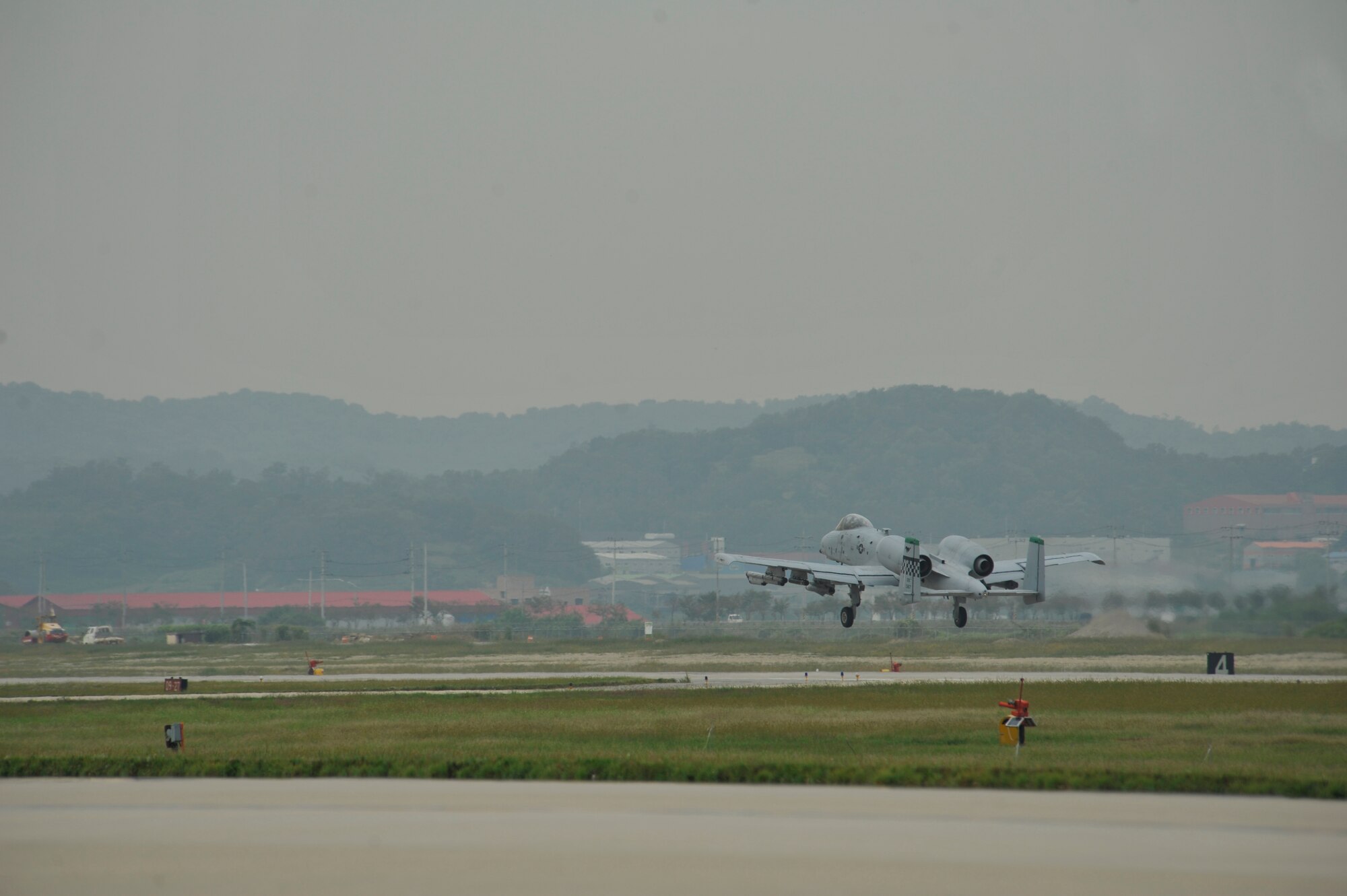 An A-10 Thunderbolt II from the 25th Fighter Squadron takes off from the runway in a mass launch during the operational readiness exercise Beverly Midnight 14-4 Sept. 17, 2014, at Osan Air Base, Republic of Korea. A total of 38 jets were launched during the mass launch. (U.S. Air Force photo by Senior Airman David Owsianka)