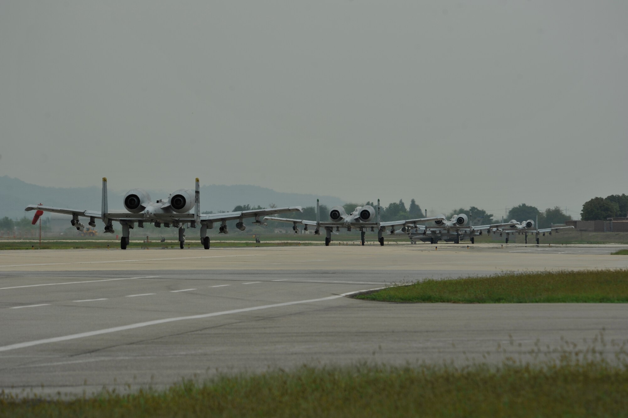 Four A-10 Thunderbolt II jets from the 25th Fighter Squadron taxi down the runway in a mass launch during the operational readiness exercise Beverly Midnight 14-4 Sept. 17, 2014, at Osan Air Base, Republic of Korea. Aircraft from Kunsan AB and Mountain Home Air Force Base, Idaho, participated in the mass launch. (U.S. Air Force photo by Senior Airman David Owsianka)