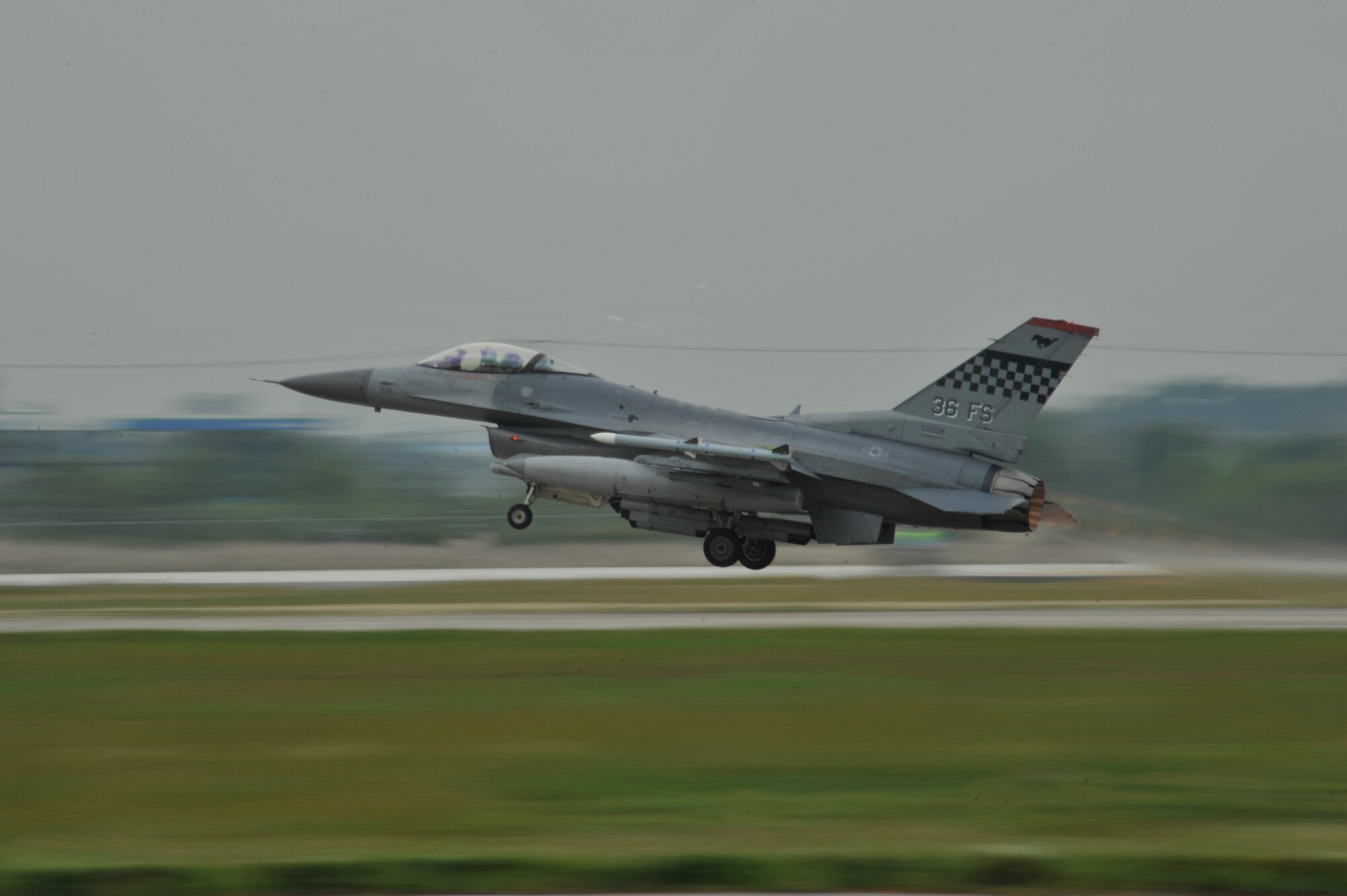 An F-16 Fighting Falcon from the 36th Fighter Squadron takes off from the runway in a mass launch during the operational readiness exercise Beverly Midnight 14-4 Sept. 17, 2014, at Osan Air Base, Republic of Korea. The jets flown during the mass launch are the A-10 Thunderbolt II, F-15 Eagle and F-16 Fighting Falcon. (U.S. Air Force photo by Senior Airman David Owsianka) 