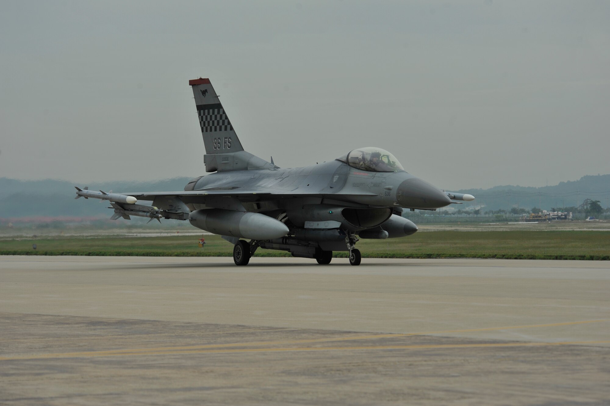 An F-16 Fighting Falcon from the 36th Fighter Squadron taxi’s down the runway in a mass launch during the operational readiness exercise Beverly Midnight 14-4 Sept. 17, 2014, at Osan Air Base, Republic of Korea. A total of 38 jets were launched during the mass launch. (U.S. Air Force photo by Senior Airman David Owsianka)