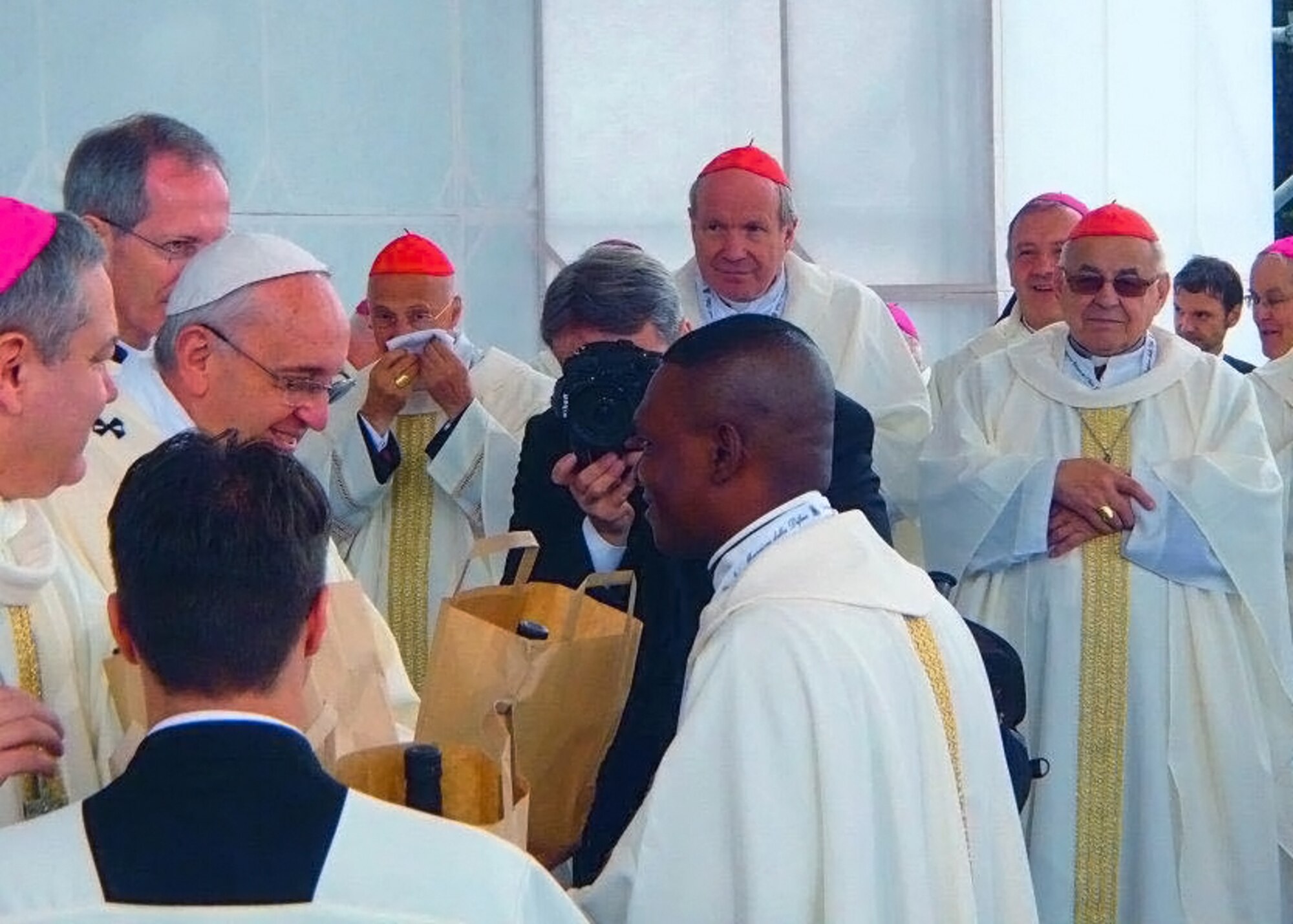 (Center) Chaplain (Capt.) Paul Amaliri, 31st Fighter Wing Catholic priest, receives a votive lamp and oil from Pope Francis during a special mass held, Sept. 13, 2014, at Redipuglia, Gorizia. The 31st FW Base Chapel took more than 180 service members and their families to attend a special mass held by the Pope in commemoration of those lost in all world wars. In addition to marking the 100th anniversary of World War I, the ceremony was dedicated to all representatives of Italian Armed Forces and their families. The Aviano Base Chapel was asked to represent Archbishop Timothy Broglio, the U.S. Archdiocese for Military Services. (Courtesy photo)